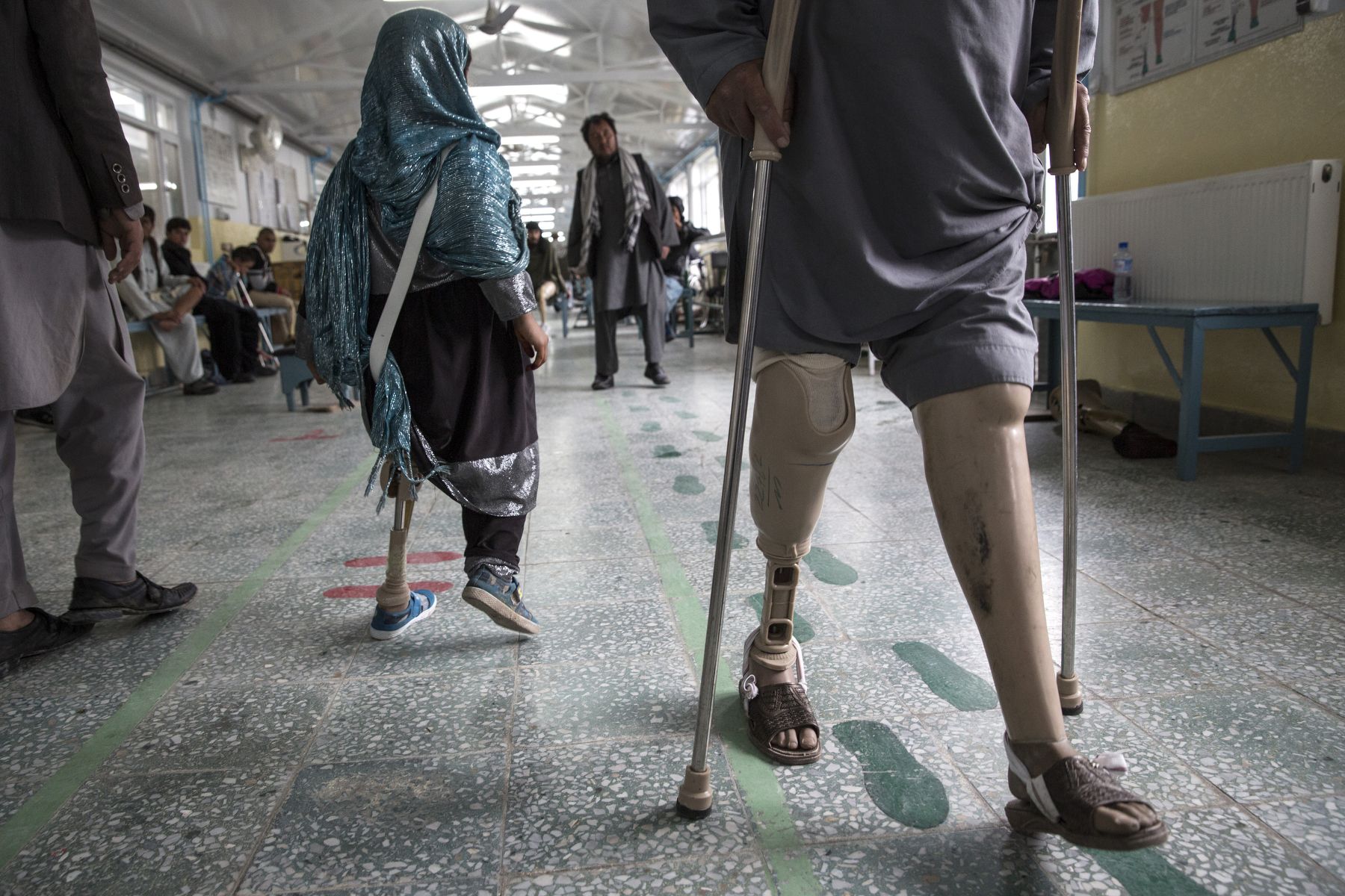 At the ICRC Orthopedic center, handicapped patients practice walking on their prosthetics in Kabul on April 2, 2016. Image by Paula Bronstein. Afghanistan, 2016.
