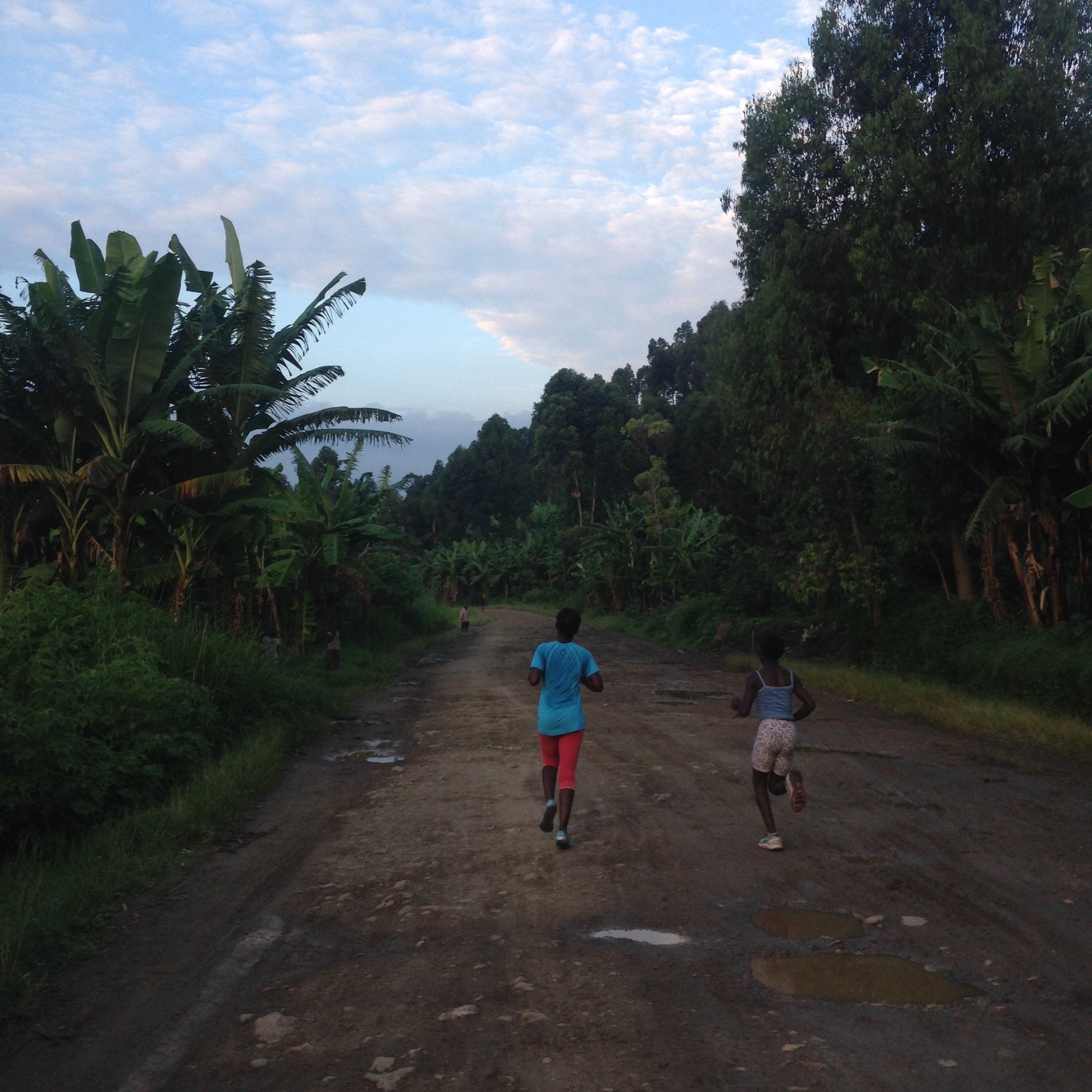 Beatrice [left] and Faraha [right] run down the main road in Kirotshe for morning practice
