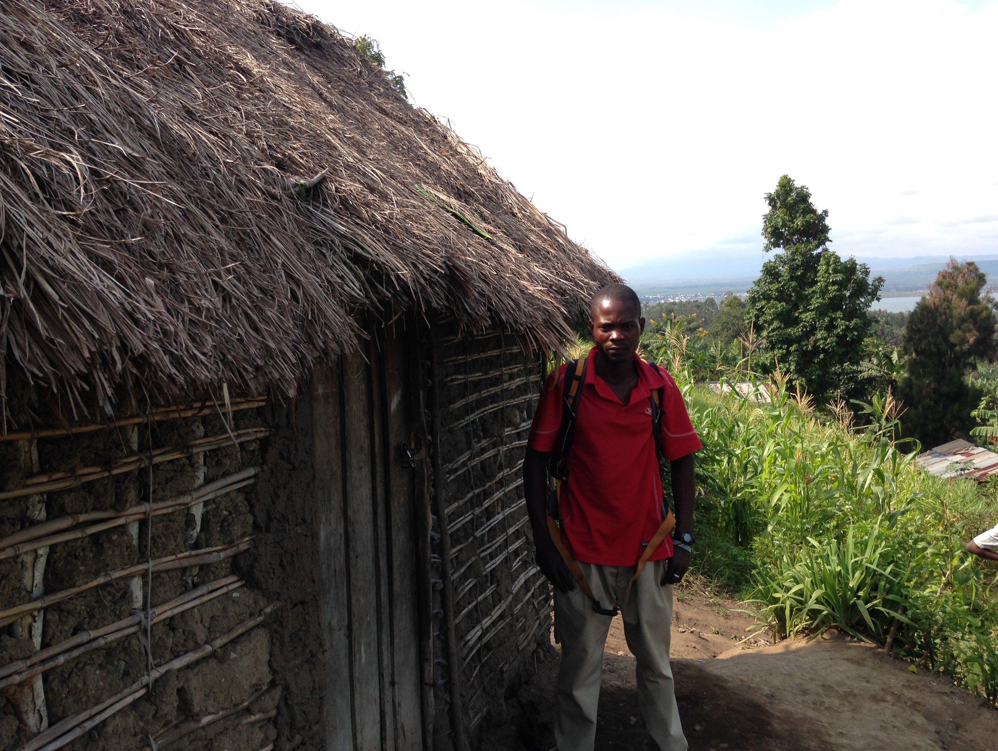 Fiston Sadiki stands in front of his home in Kirotshe
