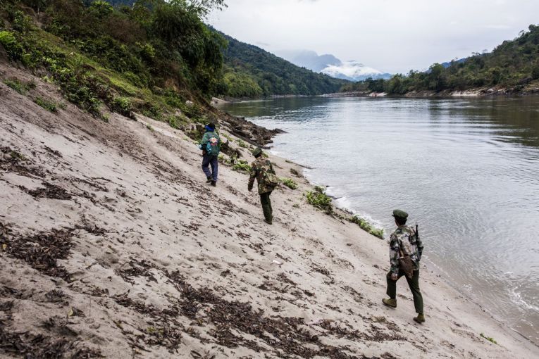 Villagers and Kachin Independence Army officers walk into the Chipwi dam project area, which was stopped in 2012 due to fighting in Chipwi, Kachin State, Myanmar. Image by Hkun Lat. Myanmar, 2019.
