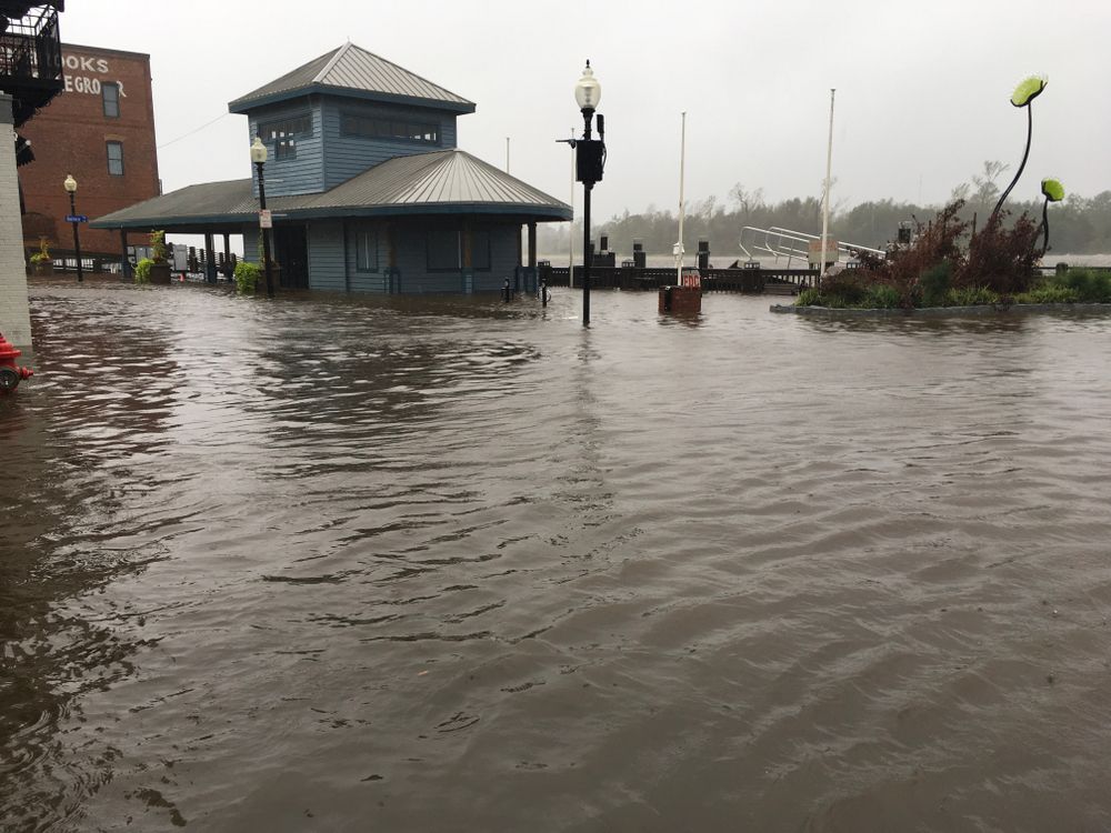 Wilmington North Carolina - USA / September 14, 2018. Downtown Wilmington begins to flood from storm surges. Visitor center on the foot of Market and Water St covered half way with flood waters. Image by MicheleMidnight / Shutterstock.com. United States, 2018.