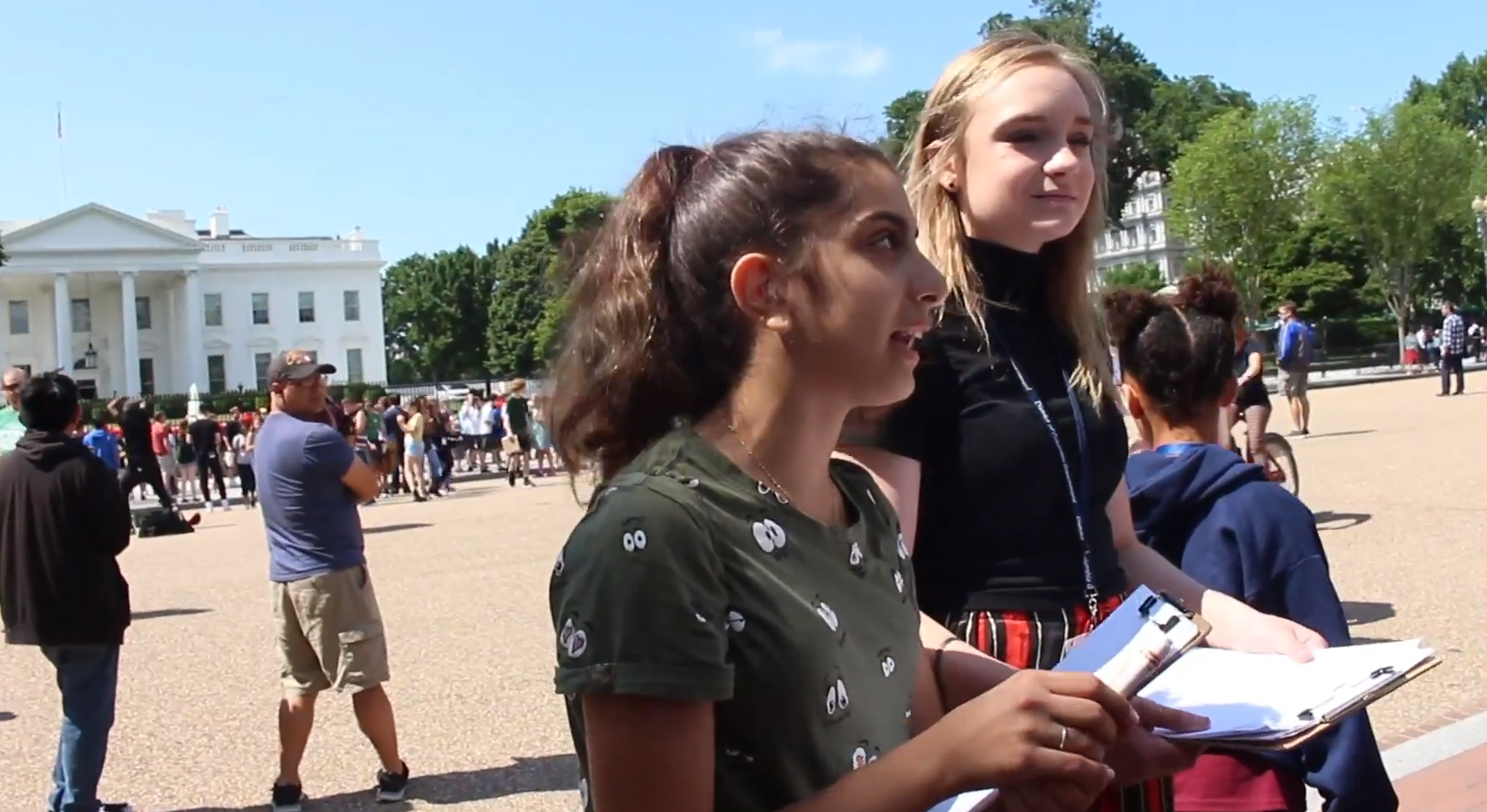 Two students interview passersby about the global issues their poems center on. Image by Kayla Sharpe. United States, 2018.