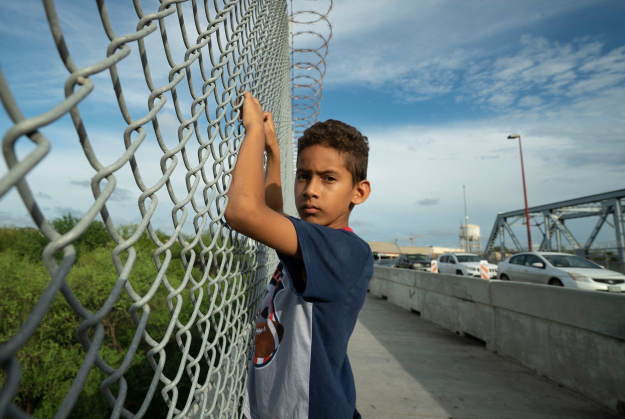 Javier Alejandro Vindel-Rodriguez on the Brownsville Express International Bridge, where U.S. Customs and Border Patrol agents deterred asylum seekers like his family from crossing the border. Image by Reynaldo Leal. United States, 2018.