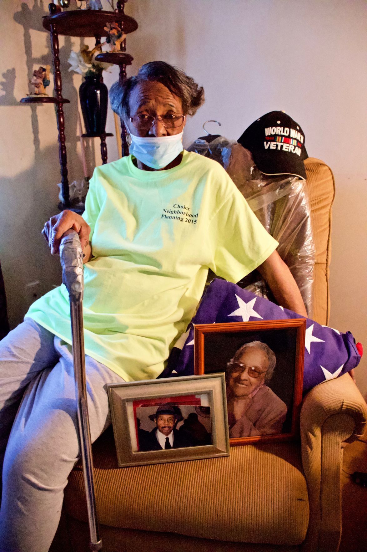 Valerie Nichols poses with photos of her mother, Willie Mae Nichols, and father, Anthony Nichols at her home in Preservation Square. Her father is deceased and her mother is living at Grand Manor Nursing and Rehabilitation Center. Image by Wiley Price/St. Louis American. United States, 2020.