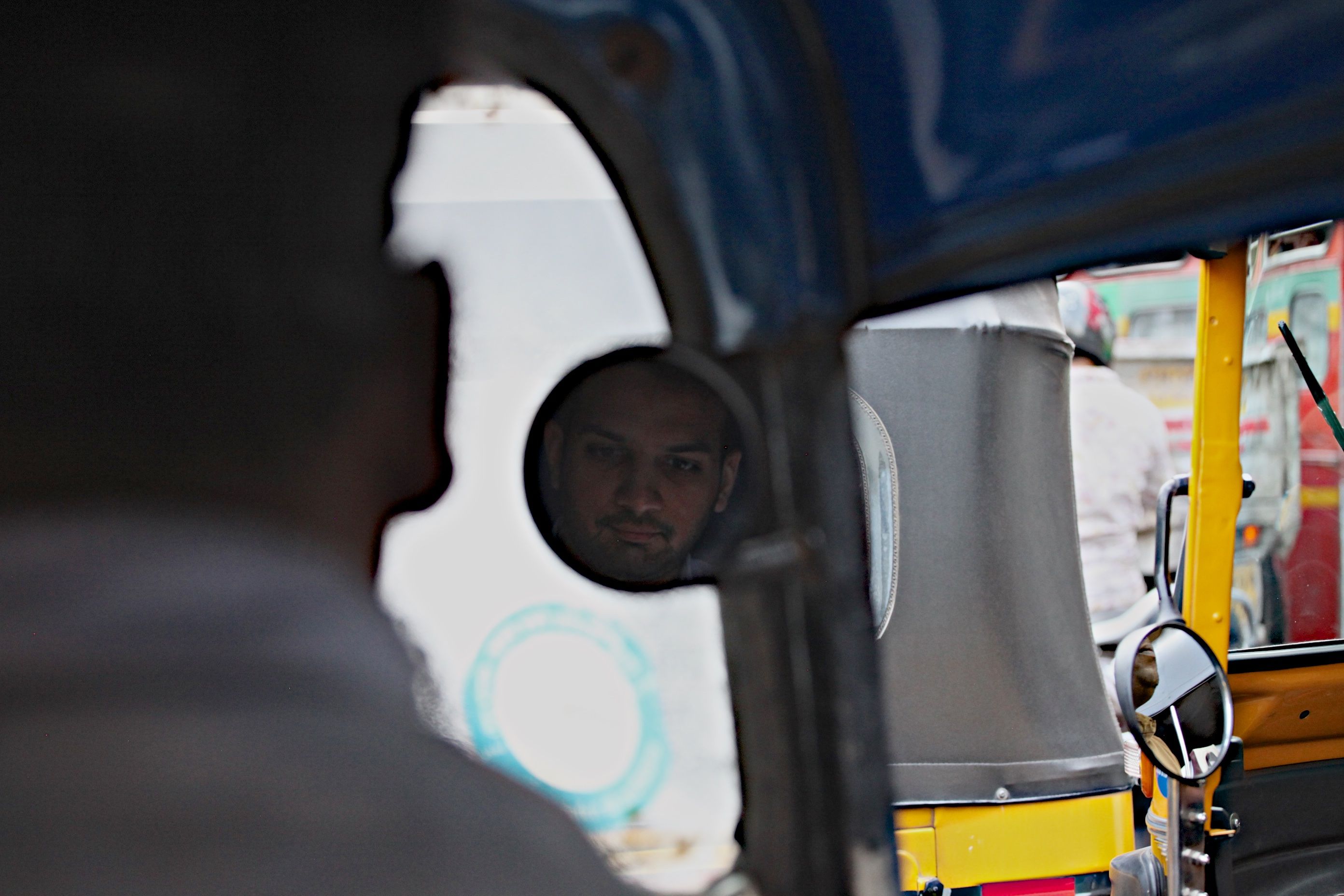 Priyank Mathur rides in a rickshaw through Mumbai. Image by Wes Bruer. India, 2017.