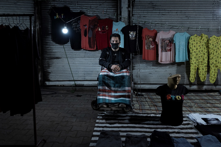 Gorgan, Iran - May, 15: Hamid, 61, from Gorgan, sustained a spinal cord injury and he has turned to the night market to make a living and pay off his debts. His average income is 85,000 tomans, about $6.  Image by Kianoush Saadati / NVP Images. Iran, 2020.