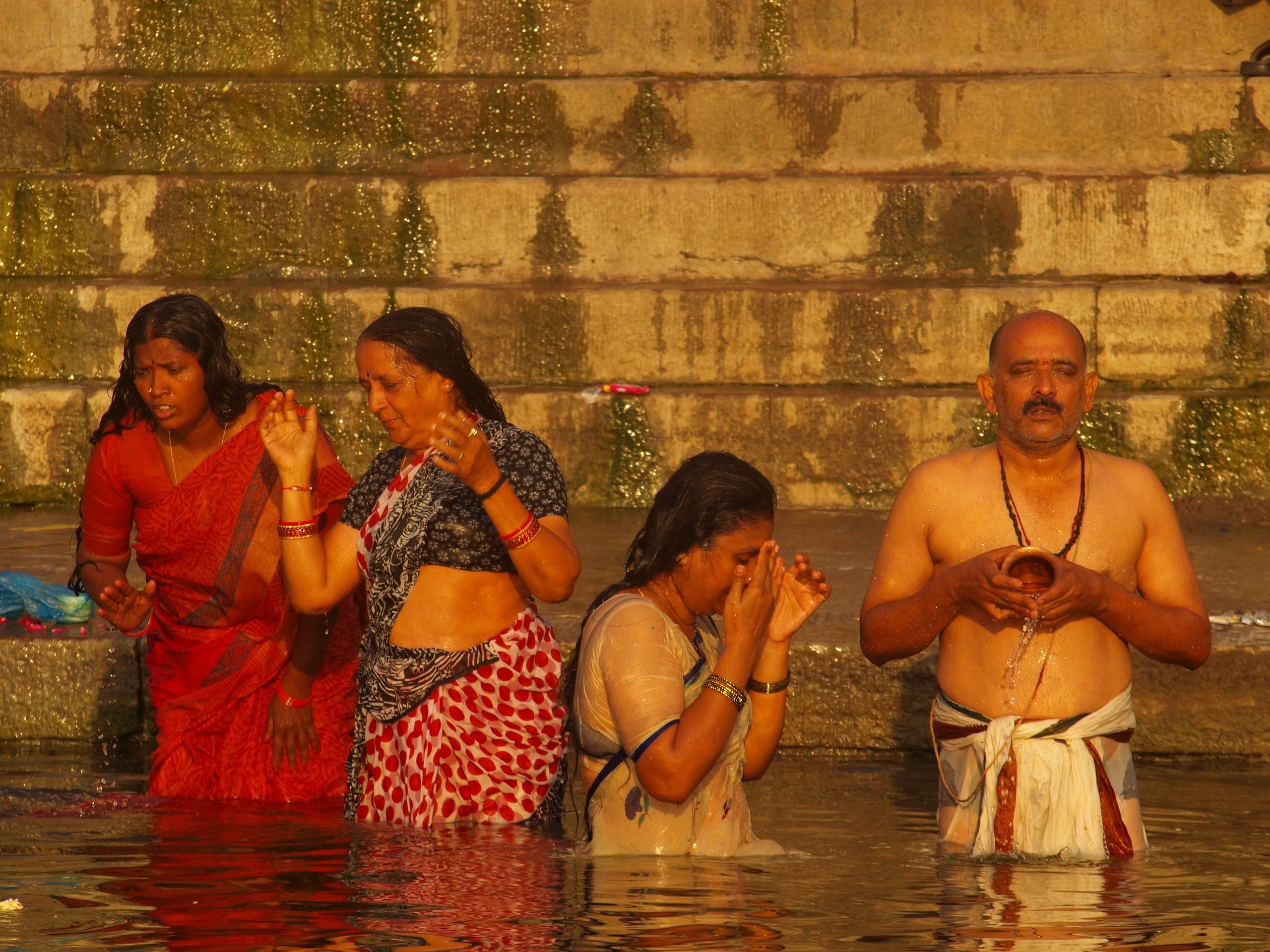Pilgrims take a “holy dip” in the sacred river. Image by George Black. India, 2015.