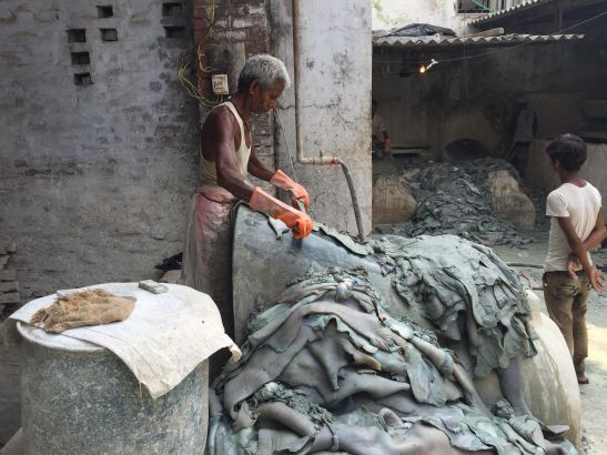 A worker sorts “wet blue” leather in a small tannery in Kanpur. Image by George Black. India, 2015.