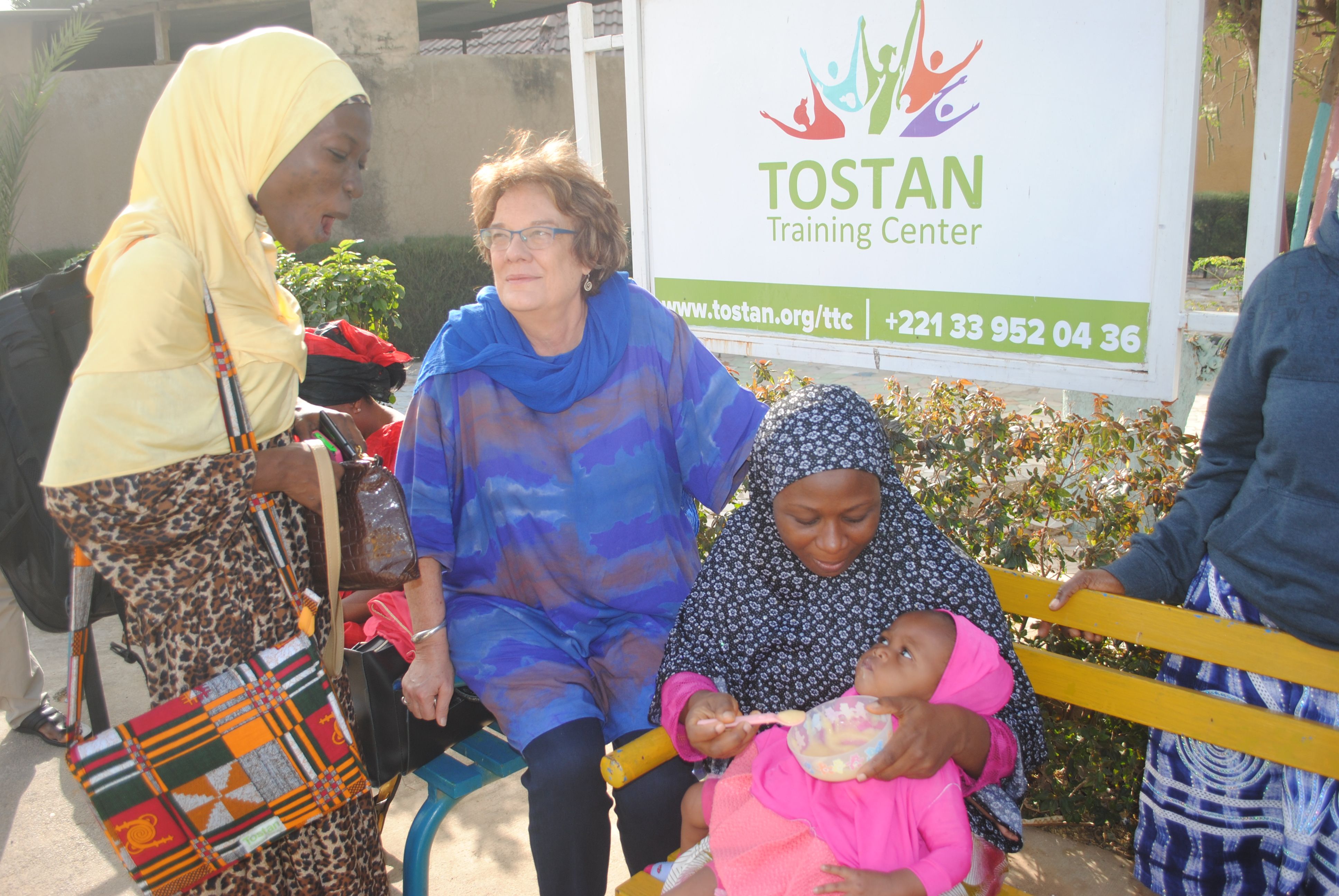 Molly Melching, founder of Tostan, a nonprofit based in Senegal, with participants from a workshop for religious and community leaders from Ghana and Nigeria. Image by Amy Yee. Senegal, 2017.
