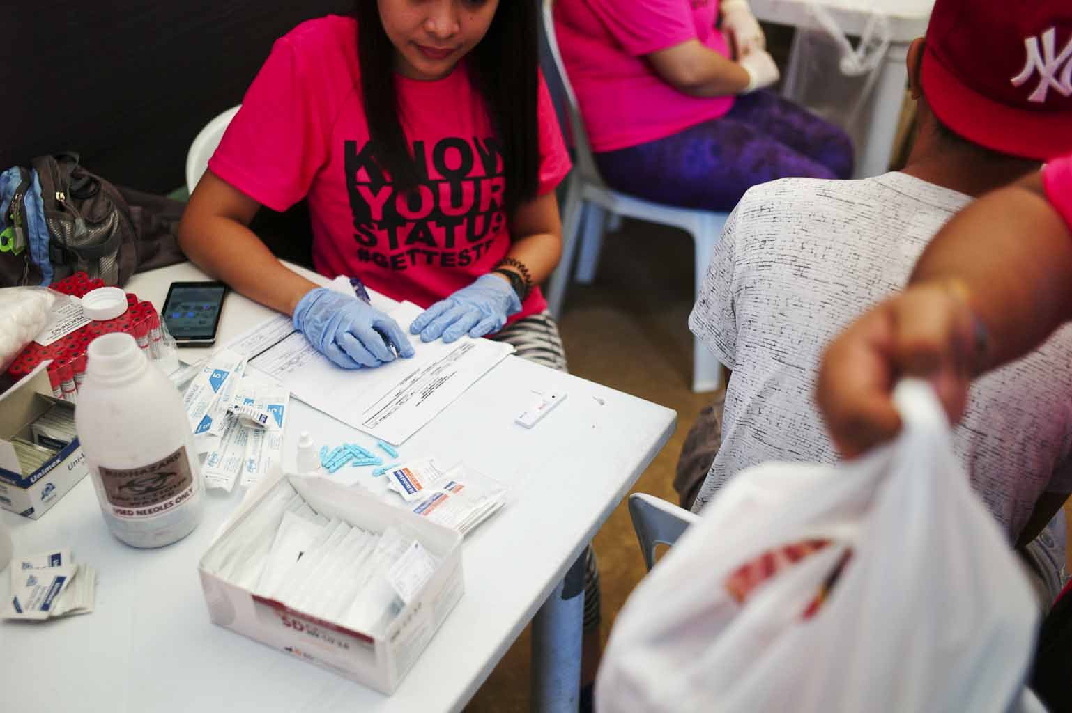 Health officials conduct rapid HIV testing during a fun run in Cebu City. Image by Veejay Villafranca. Philippines, 2015.