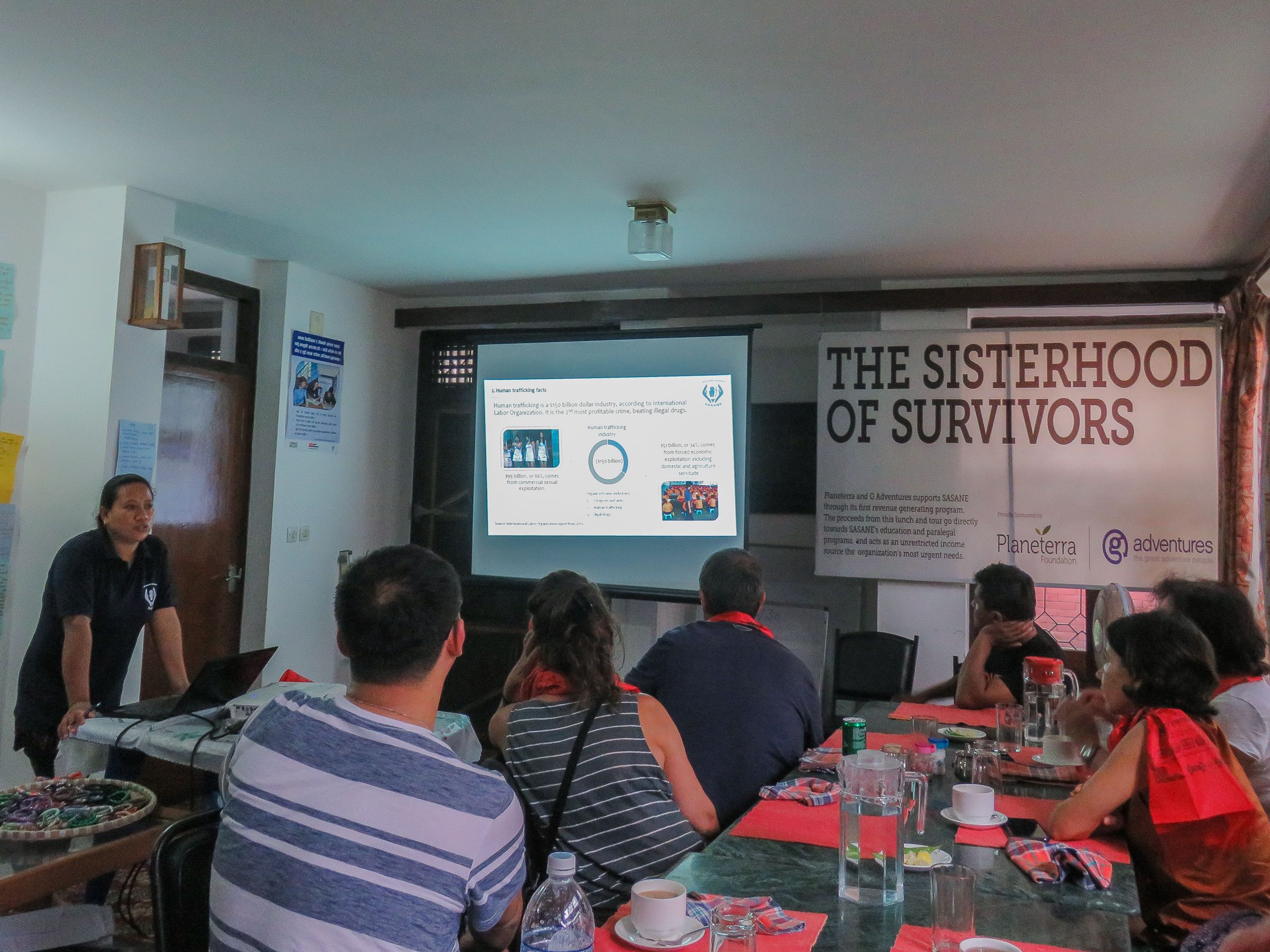 Indira Gurung, co-founder of NGO Samrakshak Samuha Nepal, discusses human trafficking in Nepal to a group of travelers. Image by Nicole Brigstock. Nepal, 2018.