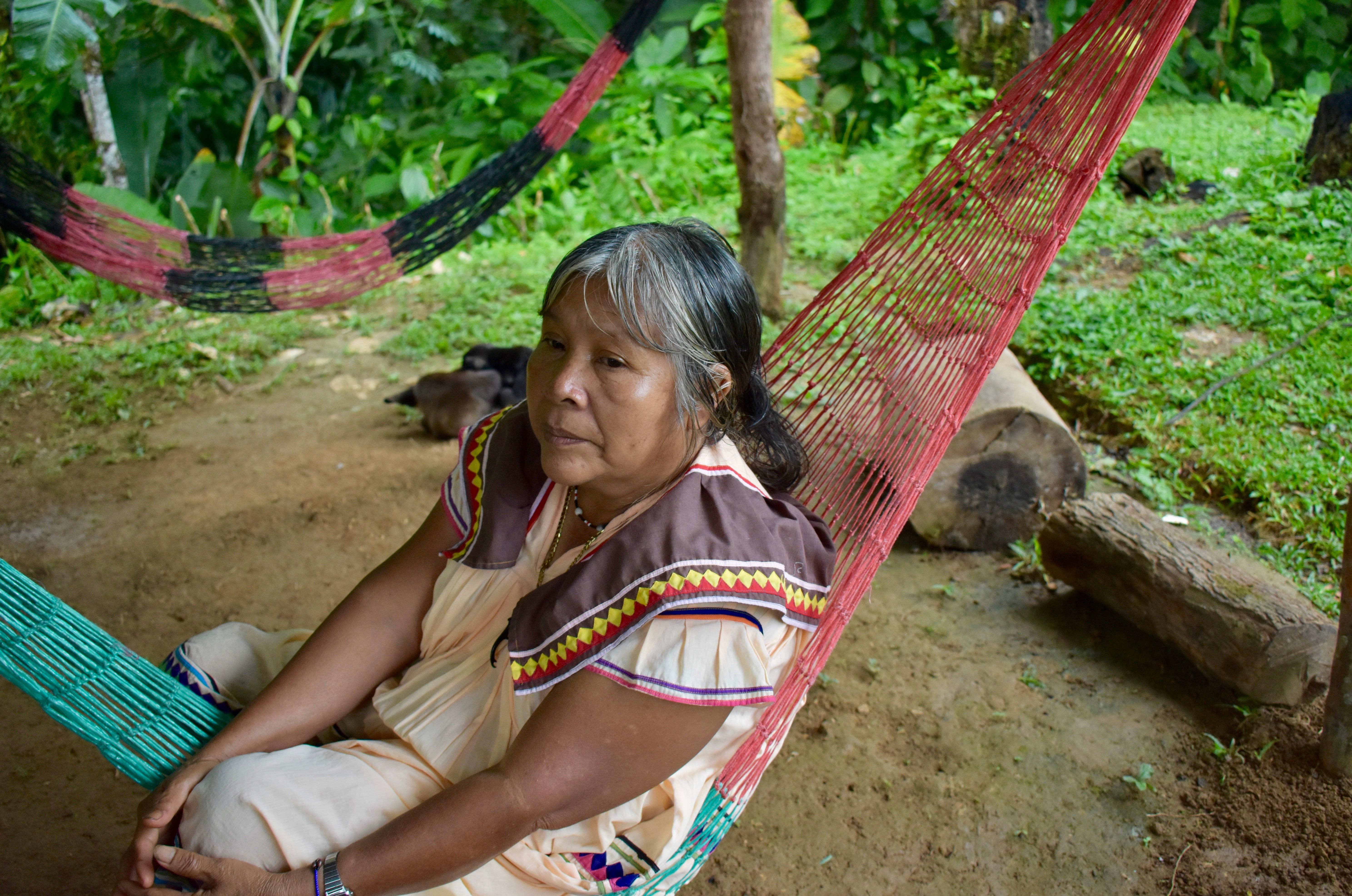 Doña Maria sits outside her home in an indigenous territory in Costa Rica, waiting to share her experiences working as a midwife for the Ngäbe-Buglé community. Image by Samira Tella. Costa Rica, 2018.
