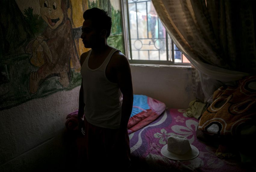 Alexander, a young man from Honduras, has been living in a house on the outskirts of Ciudad Juárez since he was sent across the border as part of the U.S. government's "remain in Mexico" program. Image by Ivan Pierre Aguirre. Mexico, 2019.