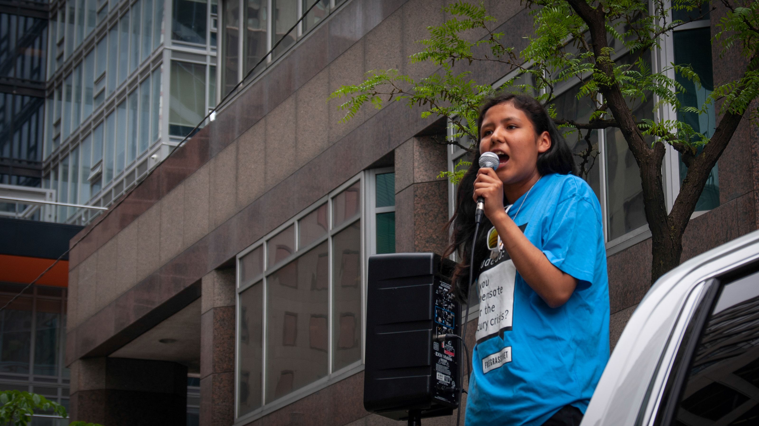 Paris Meekis, a Grassy Narrows teen, stands before the gathered crowd and speaks passionately about her community. Canada, 2019. Image by Shelby Gilson.