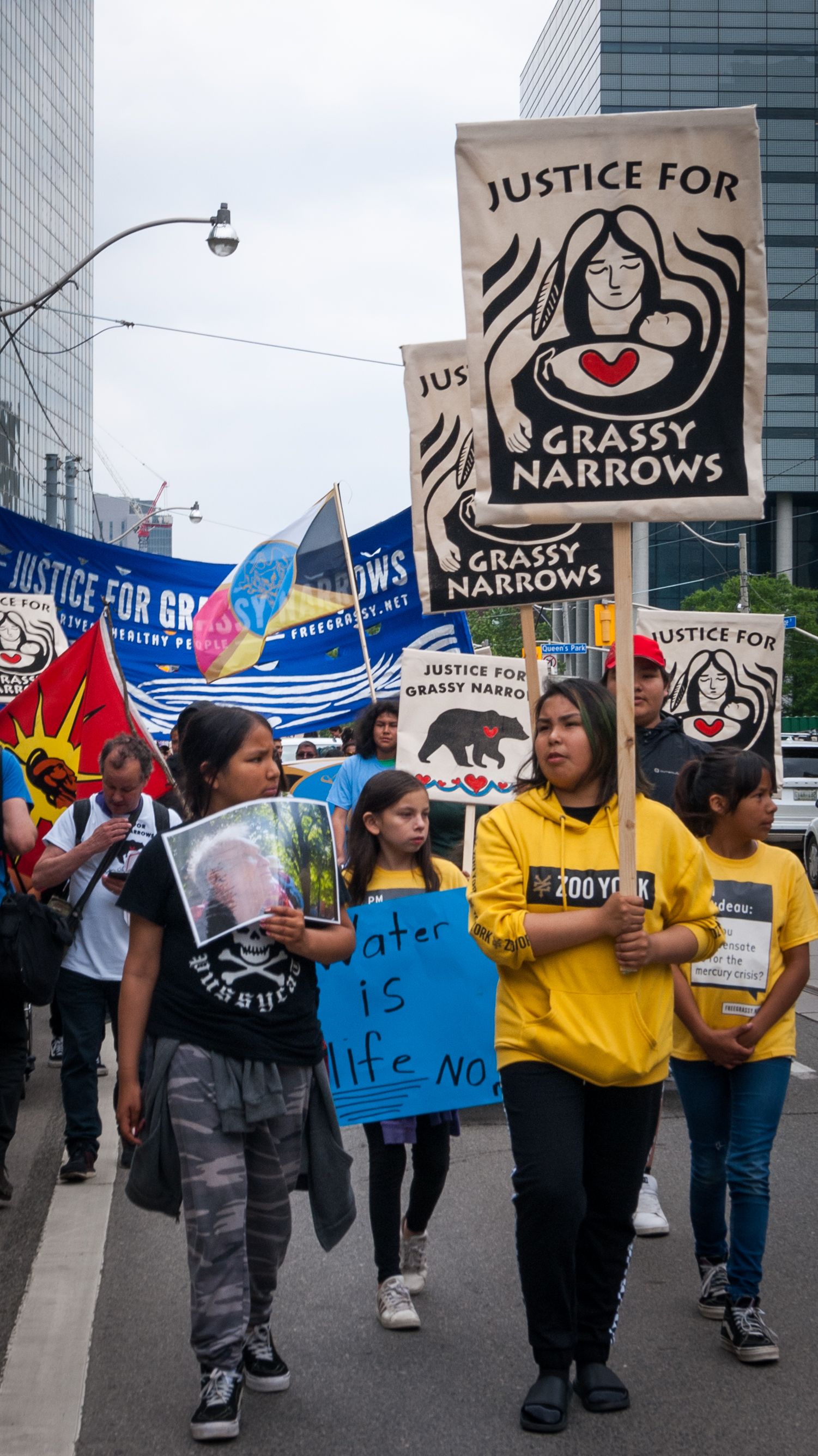A group of Grassy Narrows girls, including Jenae Turtle (second from right), gather together as they march. Canada, 2019. Image by Shelby Gilson.