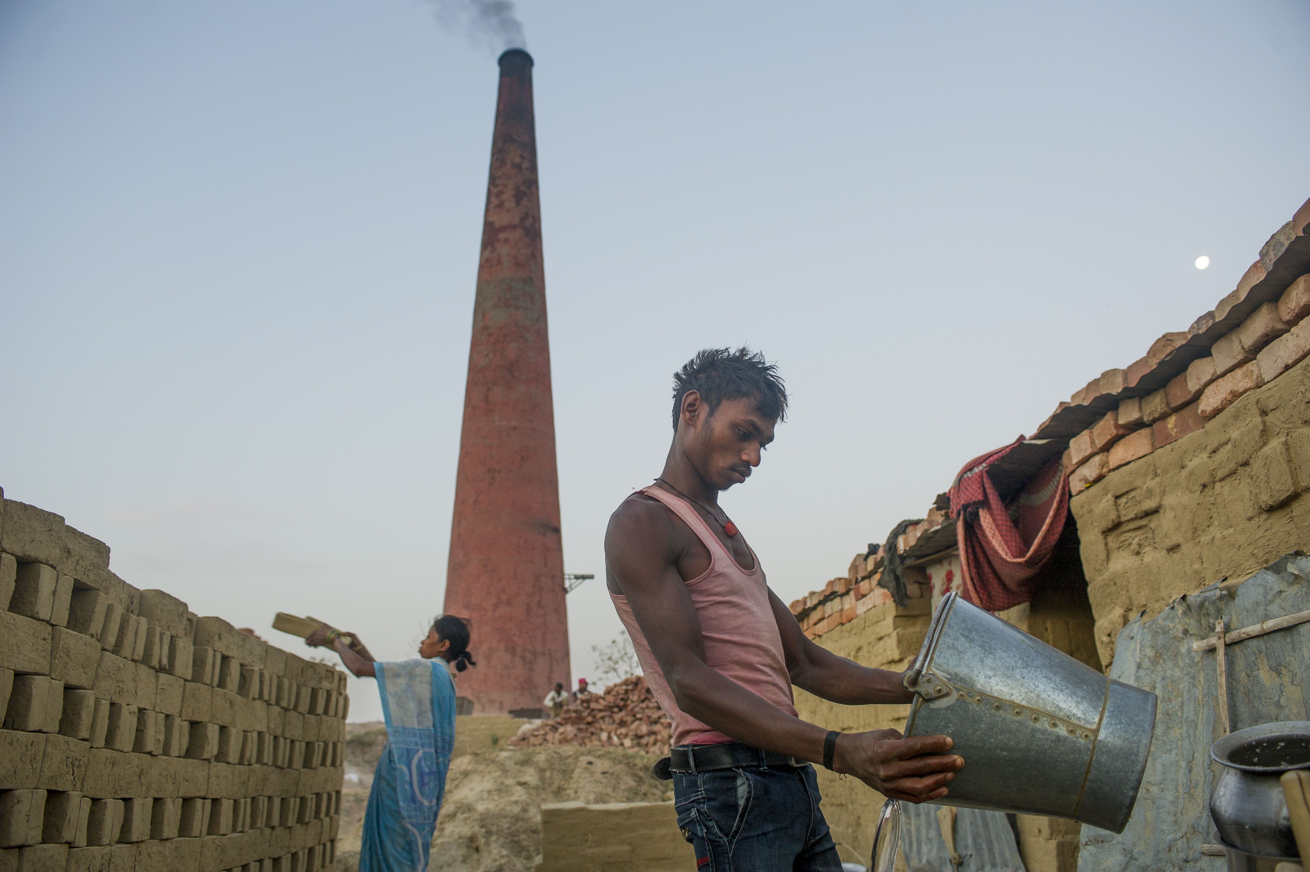 Brick molders begin work at sunrise at a brick kiln in the state of Uttar Pradesh. Image by Ann Hermes. India, 2016