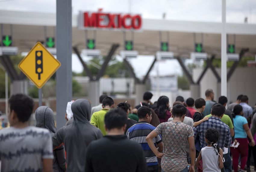 Migrants walk across International Bridge Two into Nuevo Laredo from Laredo. They requested asylum in the United States but were returned to Mexico to await their court proceedings. Image by Miguel Gutierrez Jr. United States, 2019.