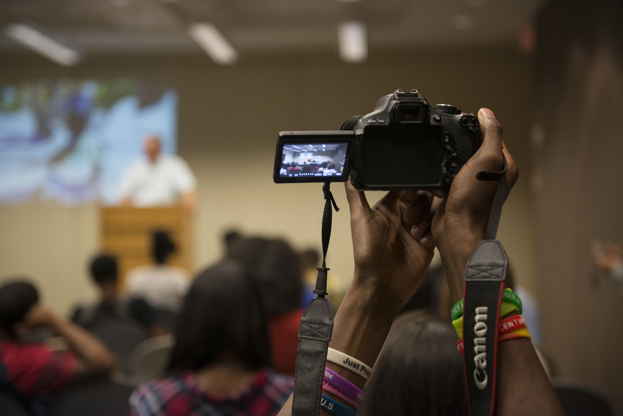 A Soul of the City student records video during Pulitzer Center grantee Roger Thurow's presentation. Image by Jordan Roth. United States, 2016.