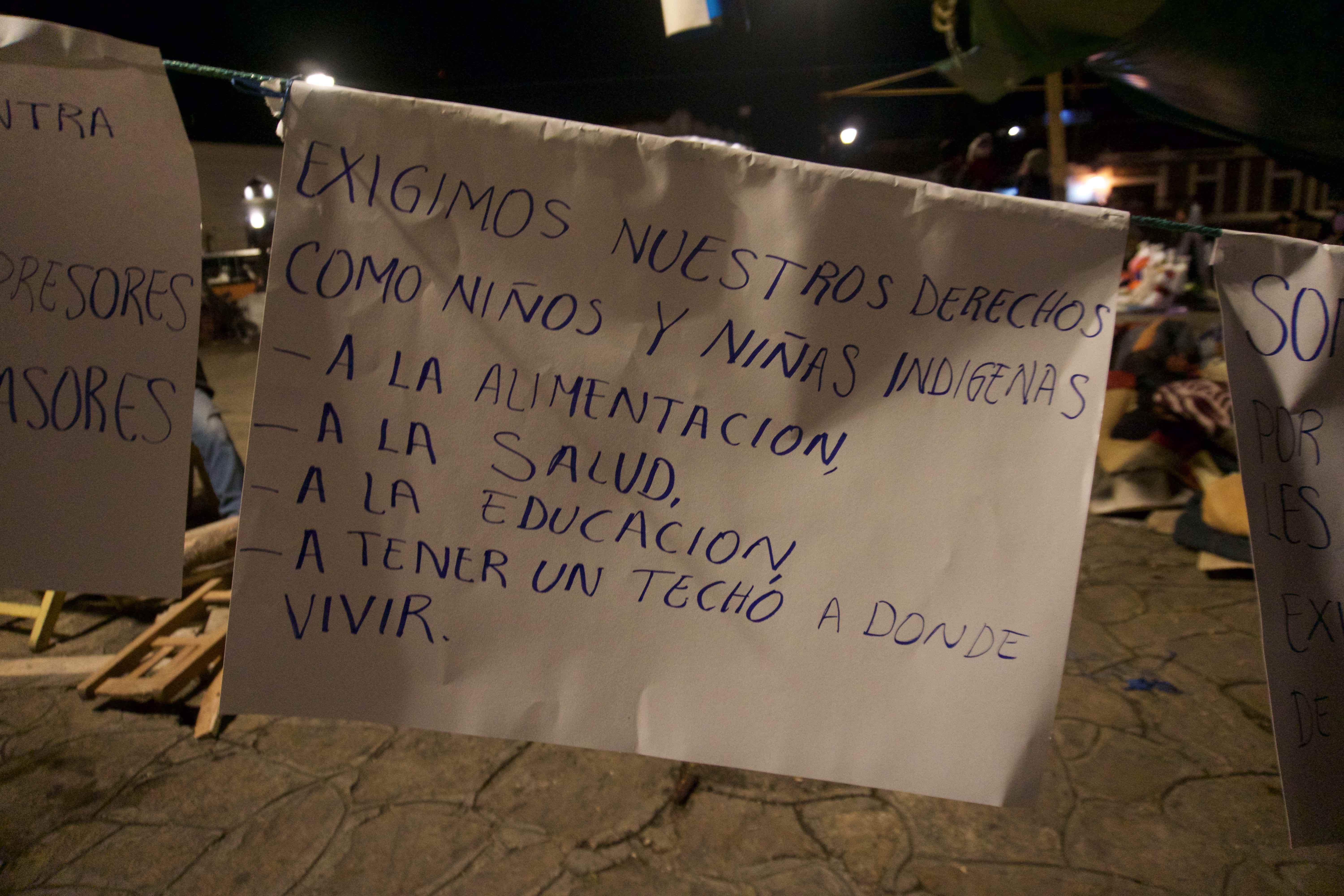 The words on a sign strung up at their makeshift encampment read: "We demand the right as indigenous boys and girls to food, health, education, and a roof to live under." Image by Jared Olson. Mexico, 2018.