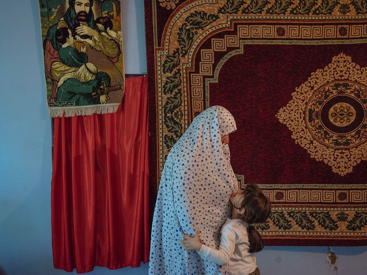 A woman chats with her daughter in teh Seydi Pir mausoleum. Image by Emin Özmen/Magnum Photos. Azerbaijan, 2018.