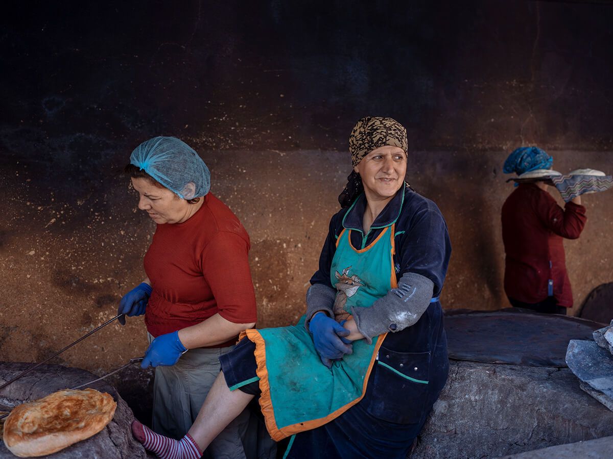 Women cook tandoor bread near a Lankaran market. Image by Emin Özmen/Magnum Photos. Azerbaijan, 2018.
