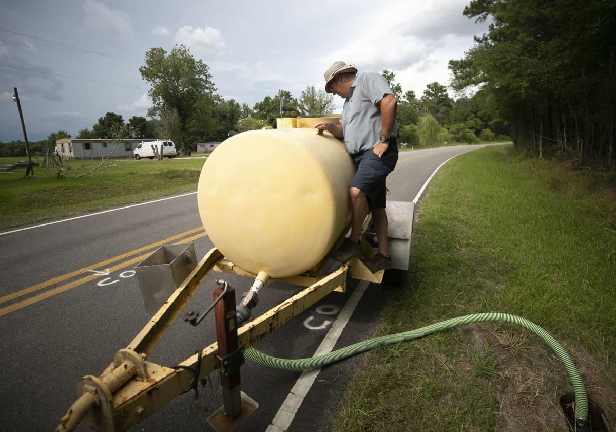 Tyrrell County Water/Sewer Department supervisor Johnny Spencer pumps out a sewer line on Davenport Road in Tyrrell County on Thursday, July 23, 2020. Image by Robert Willett / The News & Observer / North Carolina News Collaborative. United States, 2020.