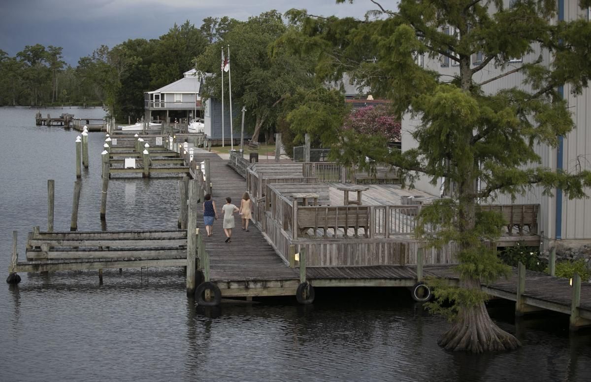 Visitors to Columbia, N.C. take a stroll along the waterfront on the Scuppernong River on Thursday, July 23, 2020. Image by Robert Willett / The News & Observer / North Carolina News Collaborative. United States, 2020.