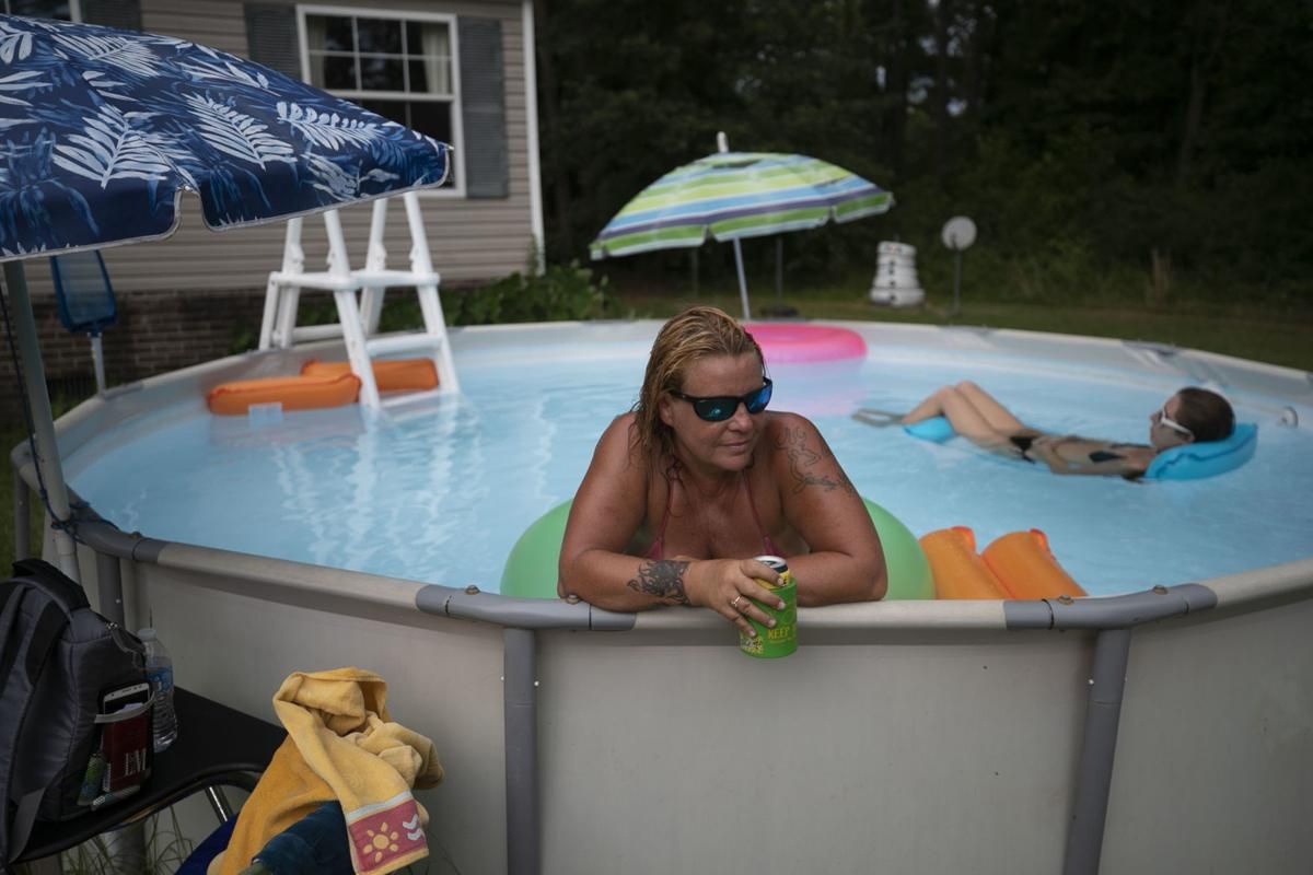 Linda Austin cools off in the pool at her home on Albemarle Church Road in rural Tyrrell County on Thursday, July 23, 2020. Austin relies on the county sewer and water system for service. Image by Robert Willett / The News & Observer / North Carolina News Collaborative. United States, 2020.