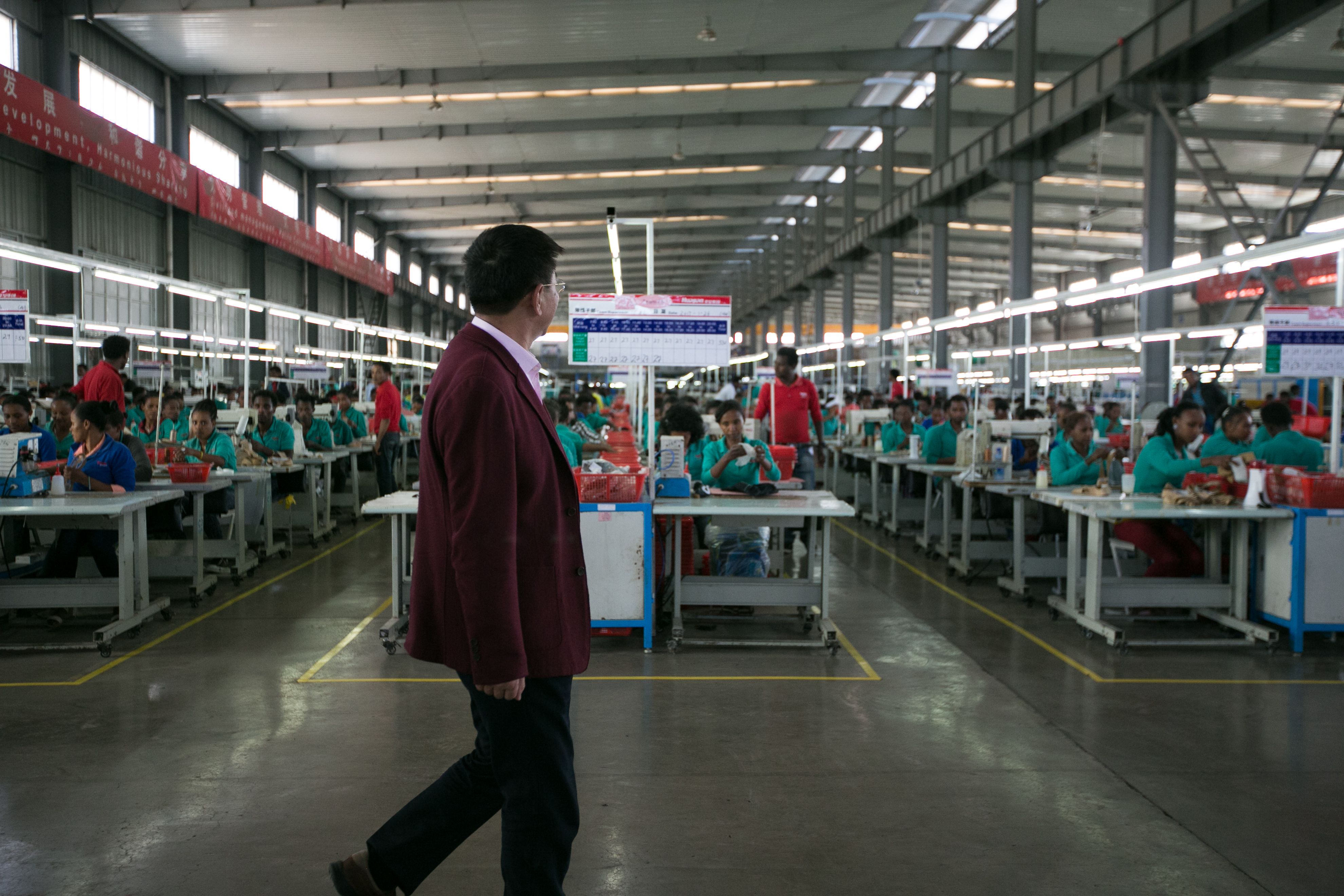 Huajian CEO Zhang Huarong conducts an inspection of the company's facilities in Addis Ababa. Image by Noah Fowler. Ethiopia, 2017.