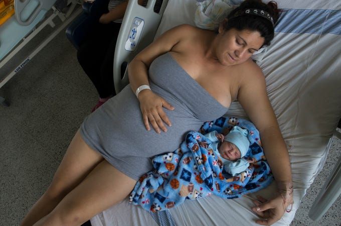 Maria Daniela Castro from Caracas with her newborn. In Colombia, due to the exodus of more than 3.7 million Venezuelans from their country, 24,000 Venezuelan babies have been born stateless since the beginning of the crisis, according to June government data. Image by Megan Janetsky. Colombia, 2019.