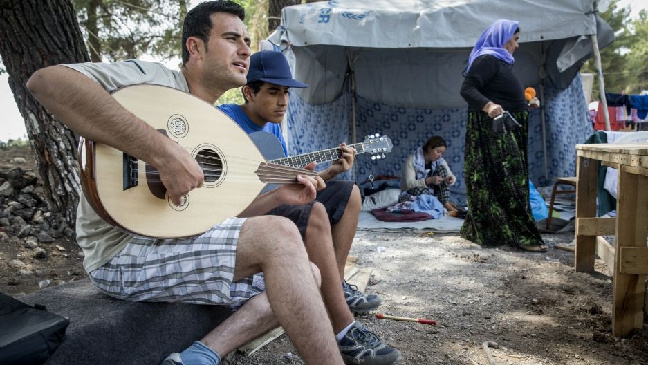 Salim Noah plays guitar with family members at Ritsona Camp, north of Athens. They are Yazidis from Dohuk, Iraq.