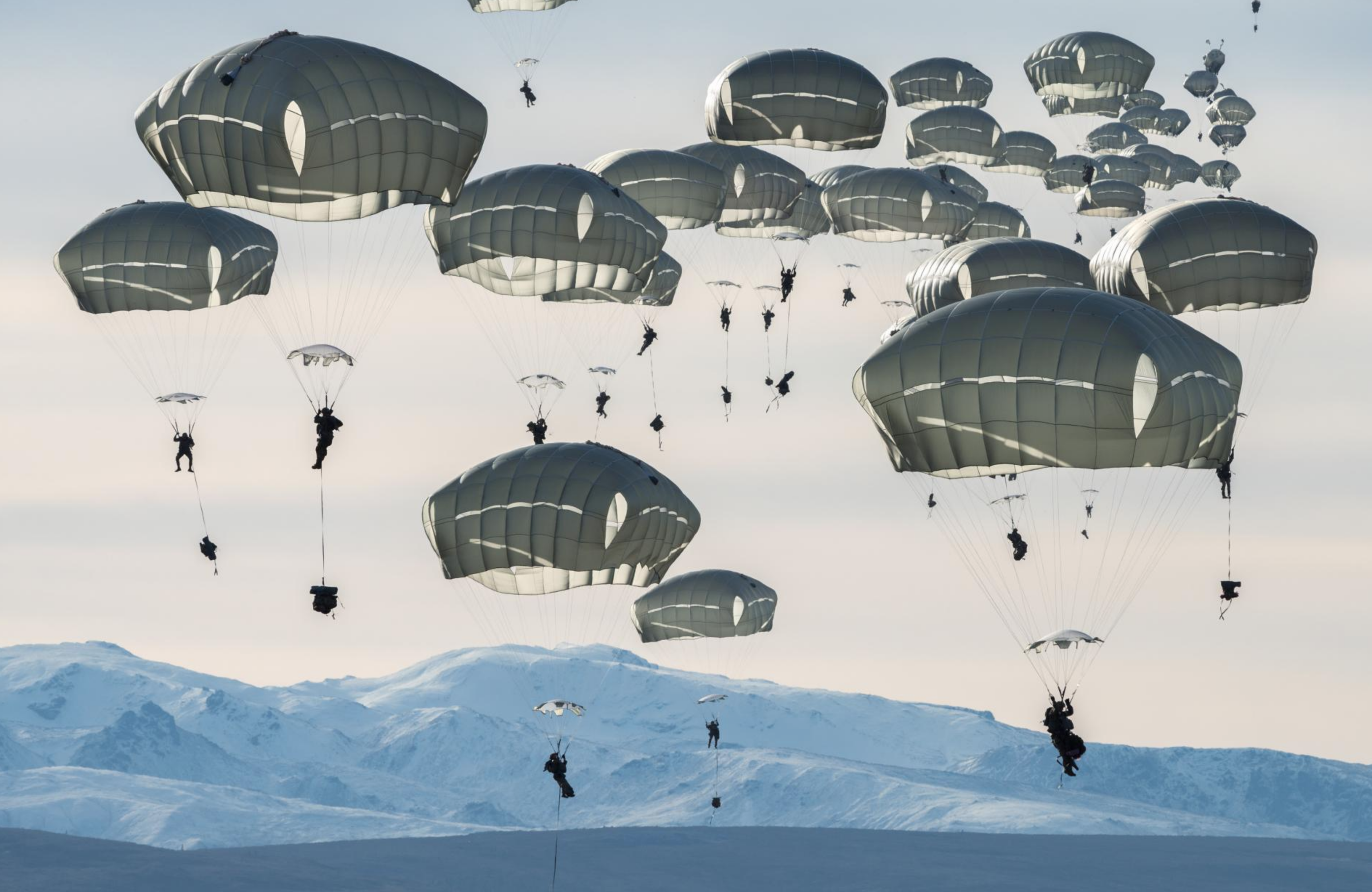 Some 400 U.S. soldiers practice parachute jumps near Alaska’s Fort Greely. The multinational exercise, which includes Canadian forces, prepares troops for the rigors of large, coordinated operations in extreme cold conditions. Image by Louie Palu. United States, 2019.