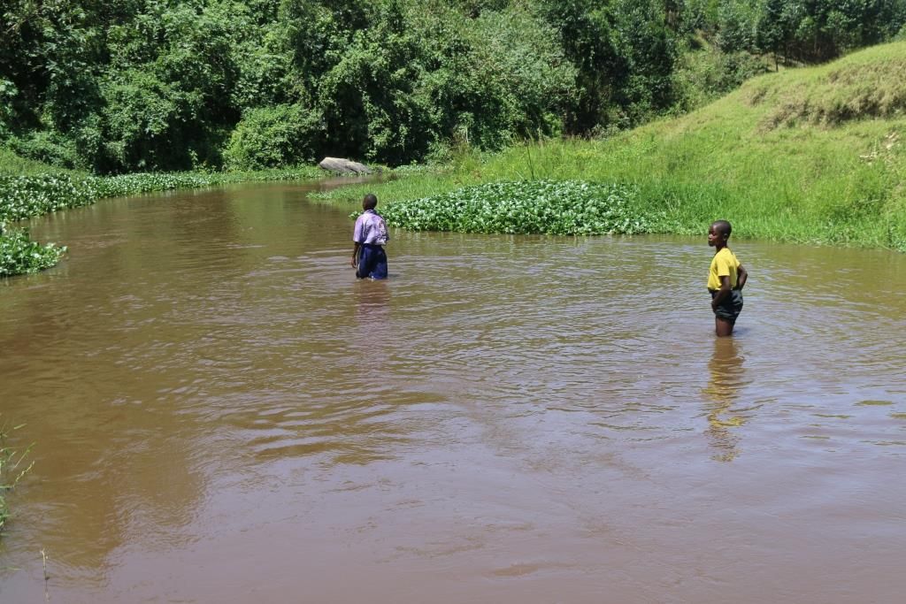 Rwizi River has been turned into a road. Residents walk through it as if it was a road. Image by Fredrick Mugira. Uganda, 2019.