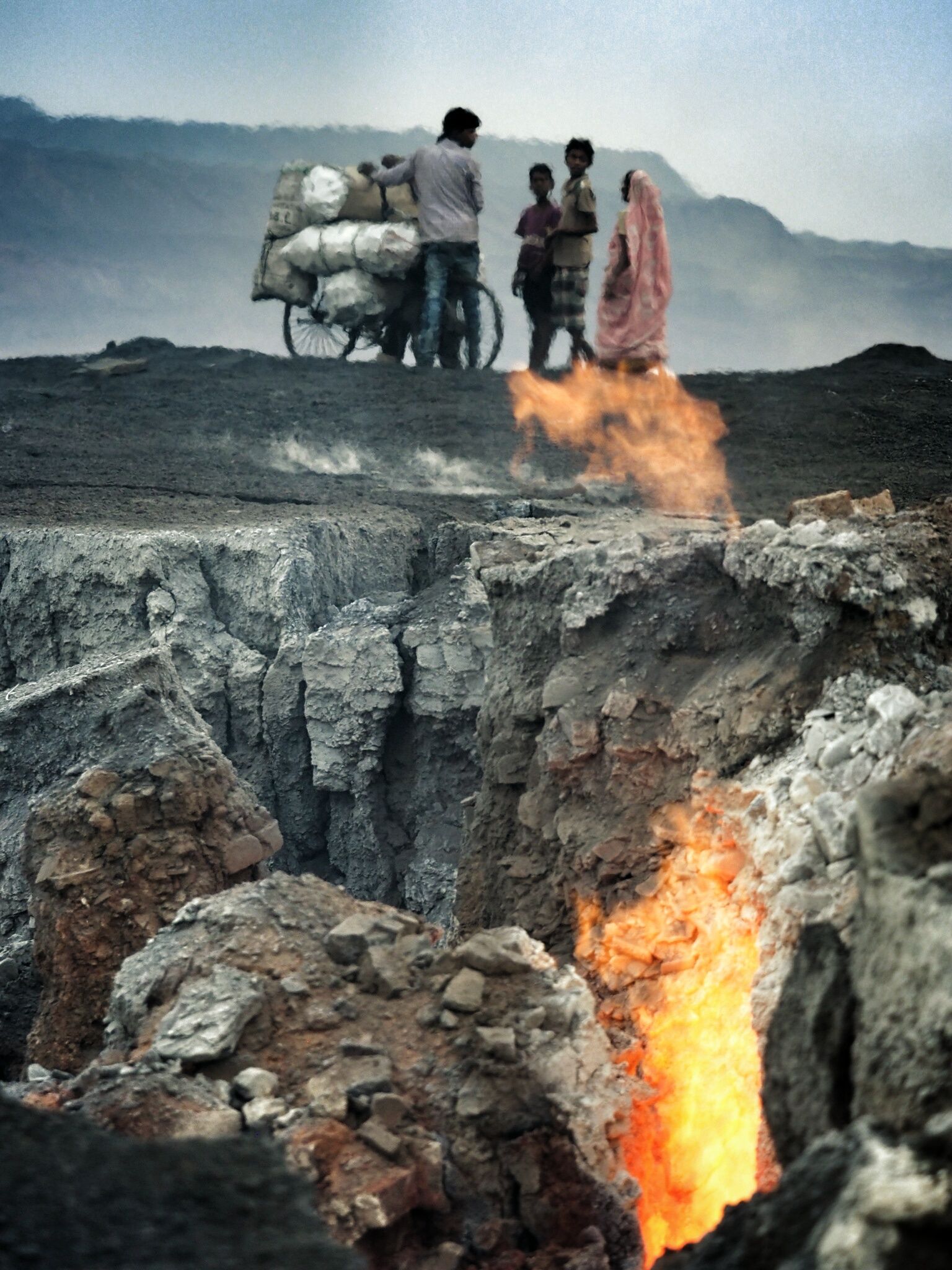 Flames leap from underground fires near the tiny settlement of Ganshadih on the edge of the Alkusha mine.