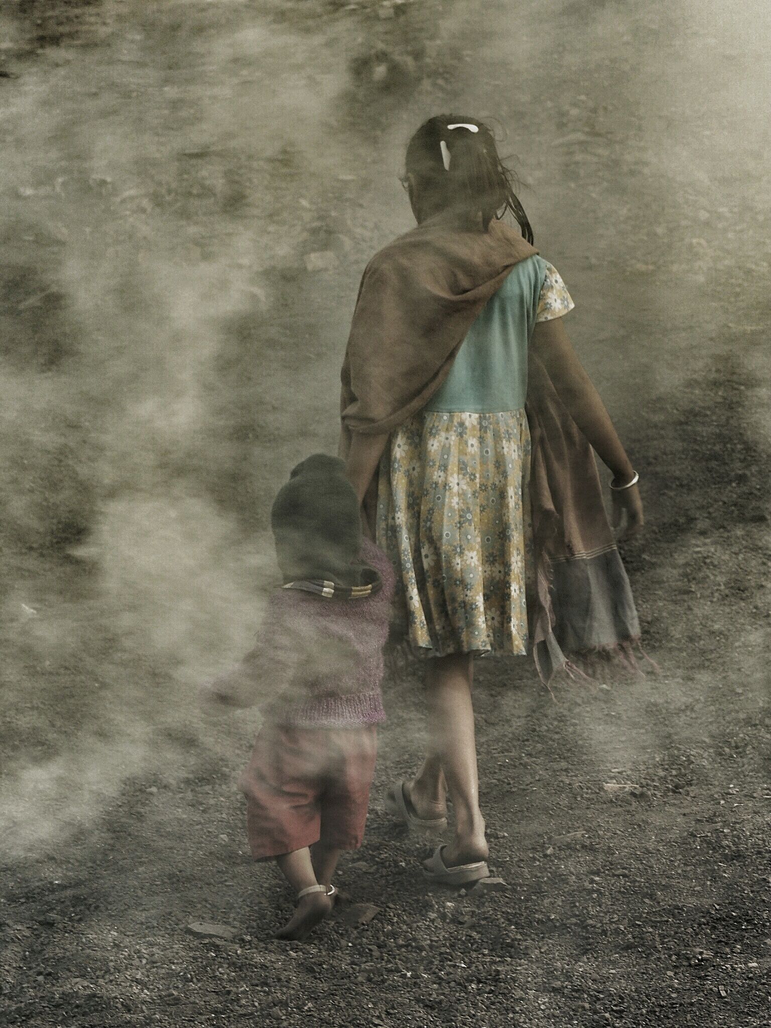 A mother leads her daughter though smoke from burning coal fires at Ganshadih.