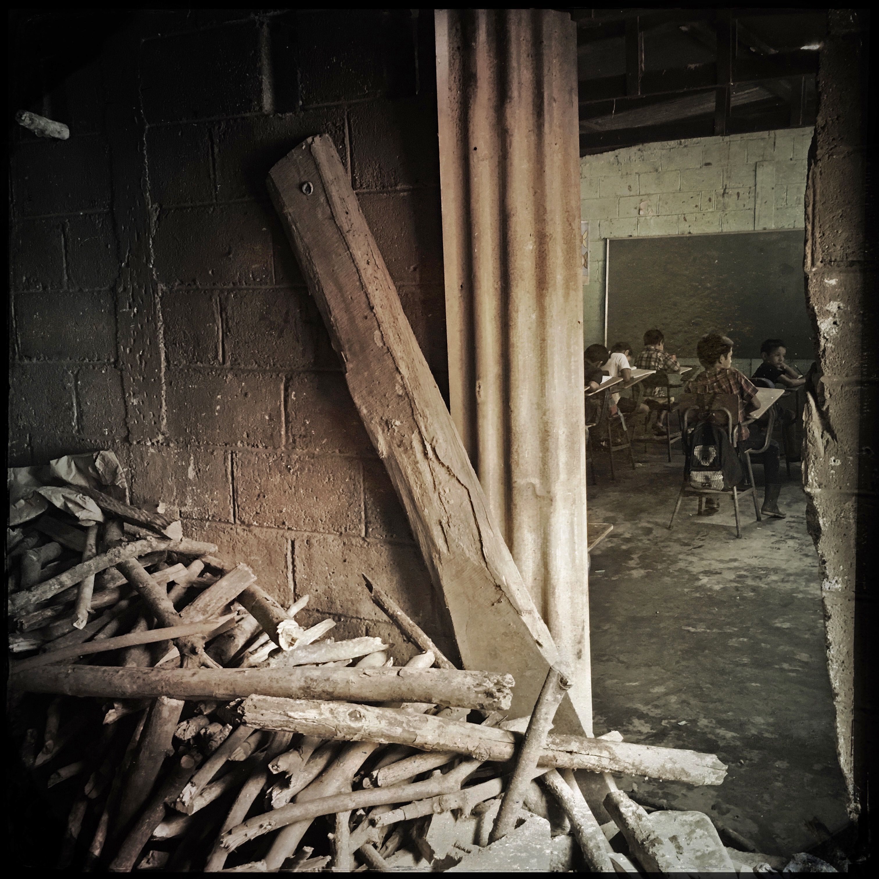 Firewood is stacked outside a classroom in Las Brisas, Guatemala. Photo by Lynn Johnson. Guatemala, 2017.