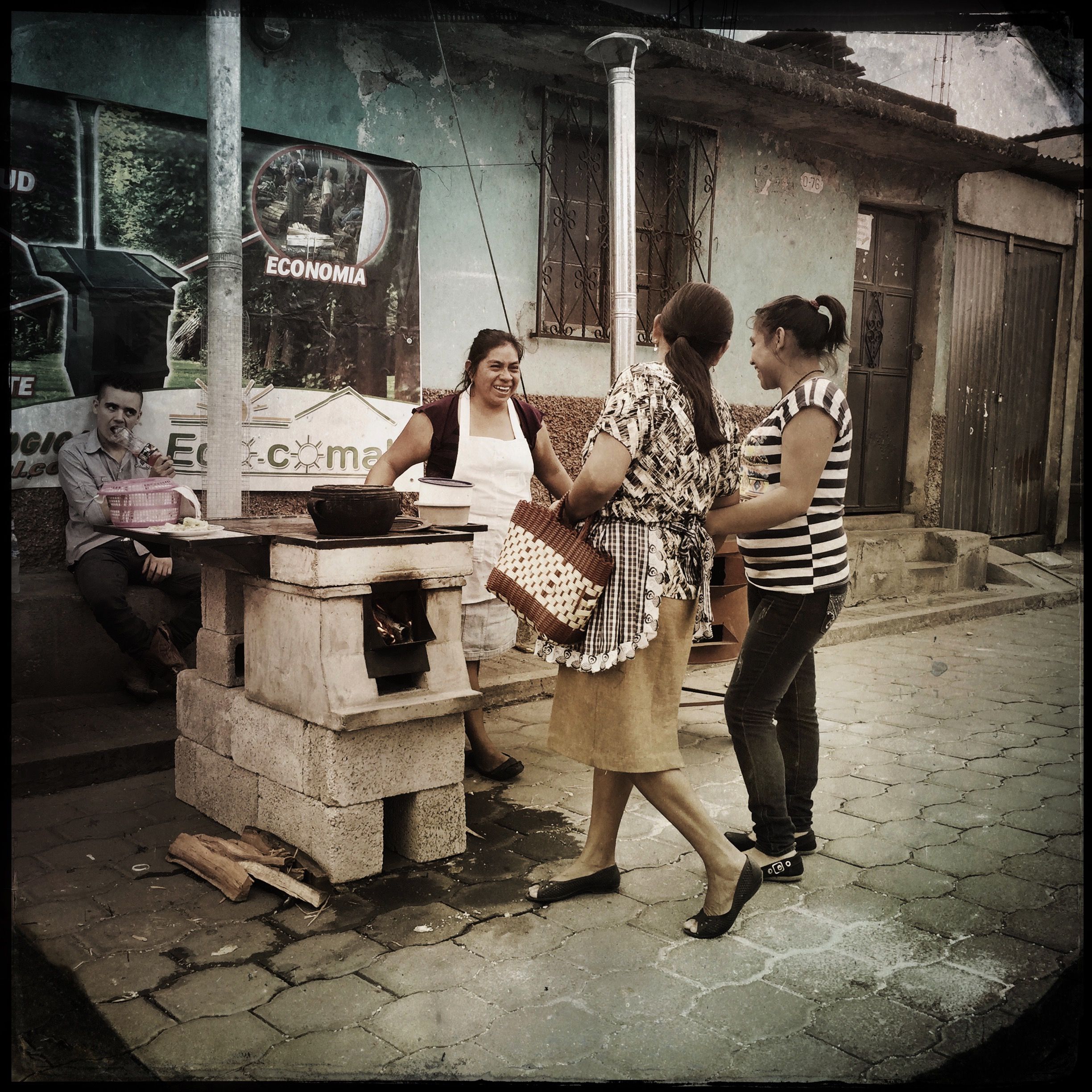 Representatives of the EcoComal stove company sell their efficient cookstoves on market day in San Antonio Aguas Calientes, Guatemala. For a stove to be fully accepted by a household, both stove and fuel must be affordable, accessible, and easy to use—goals that aren’t easy to achieve simultaneously. Photo by Lynn Johnson. Guatemala, 2017.