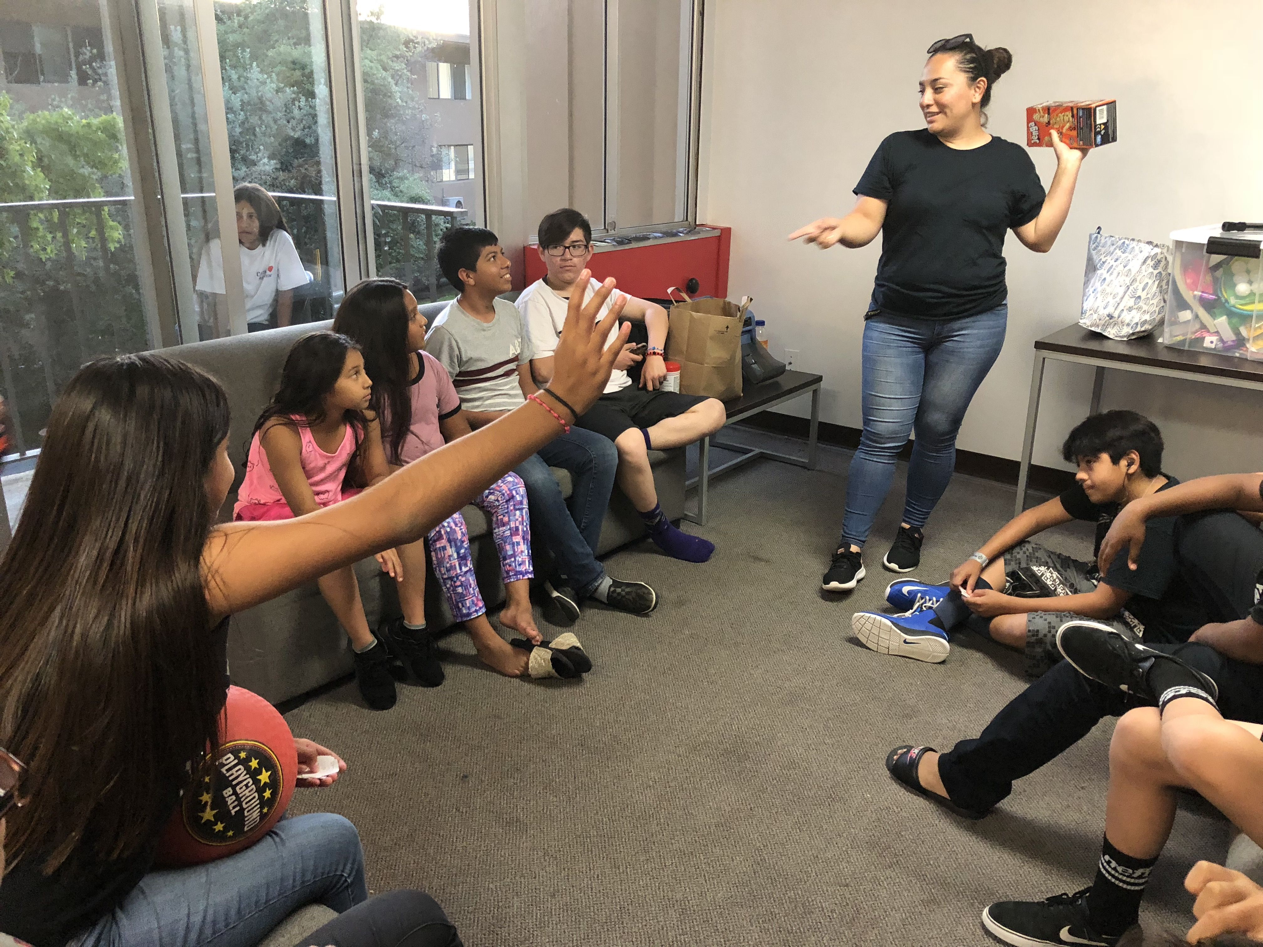 On the last night of Camp Suzanne, kids participate in a raffle in the common area of a Holy Names University dorm. Image by Jaime Joyce for TIME Edge. California, 2018.