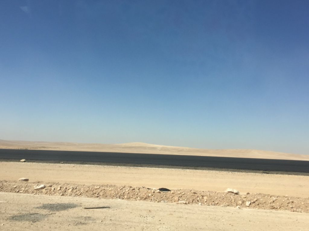 The road leading up to Azraq reveals stark differences from the city near Za'atari. Looking out from Azraq camp, this view is essentially unbroken in all directions. Image by Rachel Townzen. Jordan, 2016.