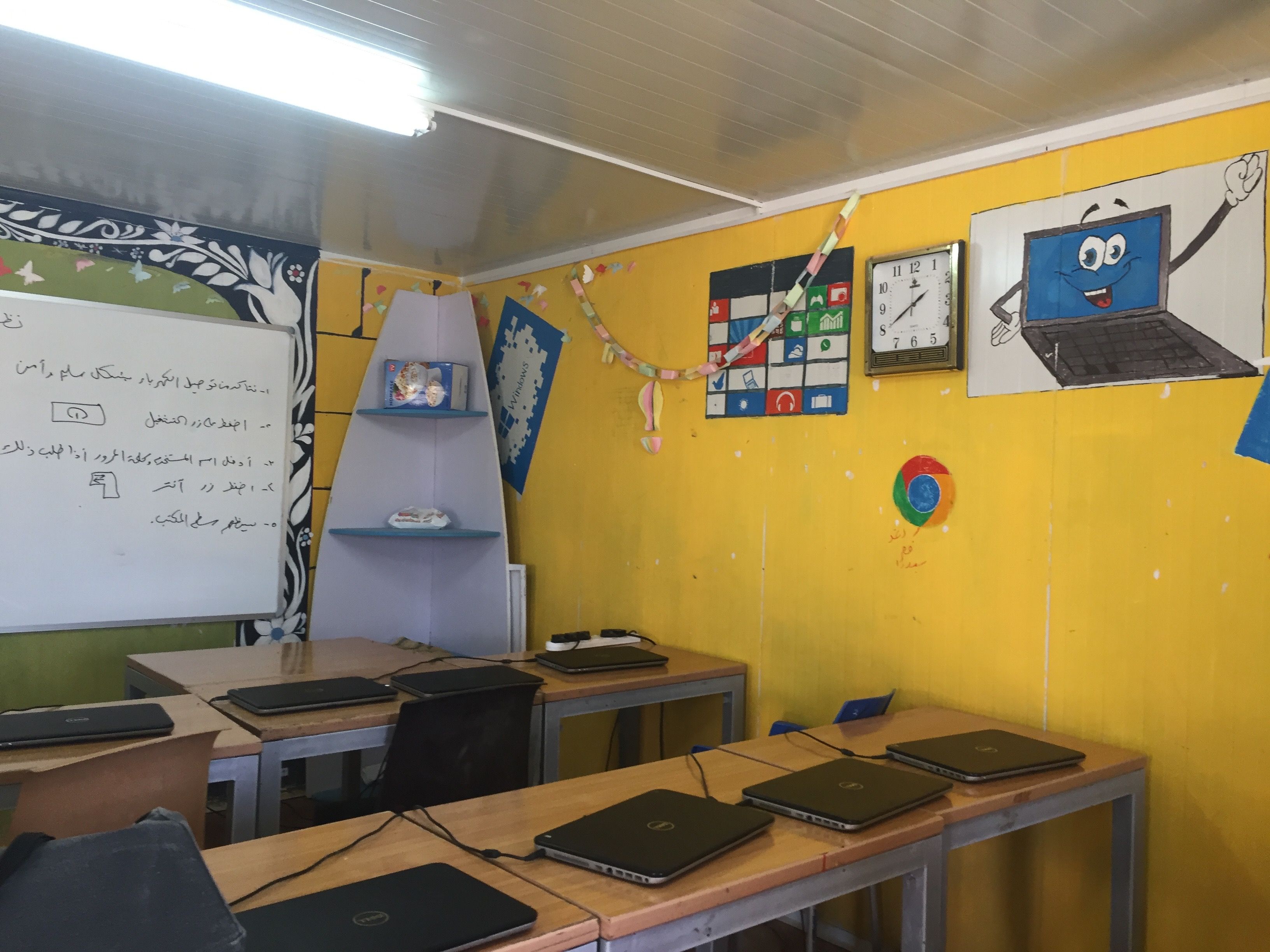 A computer classroom in Azraq Camp. Despite images for Google Chrome, the laptops cannot connect to use this browser for lessons. Image by Rachel Townzen. Jordan, 2016.