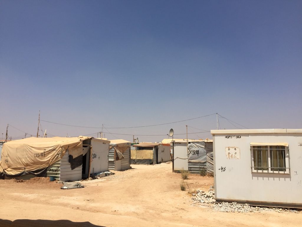 Za'atari Camp has now been open for over four years. Among its many developments, power lines and satellite dishes appear almost everywhere, connecting a sprawling jungle of caravans. Image by Rachel Townzen. Jordan, 2016.