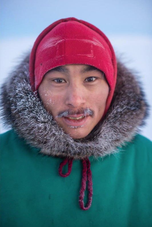 Andy Issigaitok and other reservists teach traditional Inuit techniques such as hunting, navigating, and building igloos. Image by Louie Palu. Canada, 2019.