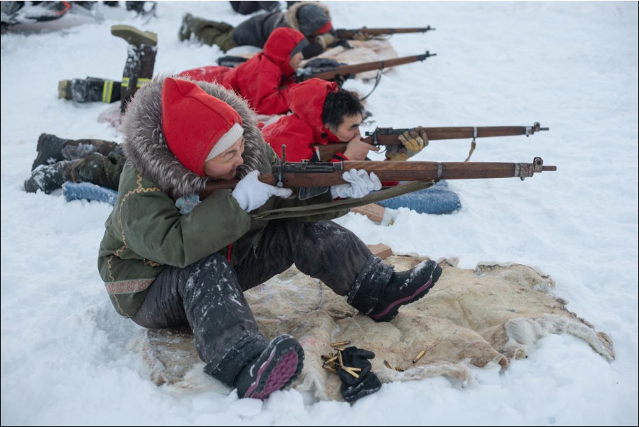 Training to survive in extreme conditions, Susie Hiqinit and the rest of the Canadian rangers in her volunteer reserve unit practice firing .303 bolt-action rifles. Nearly every community in Canada’s high Arctic has a ranger patrol. Image by Louie Palu. Canada, 2019.