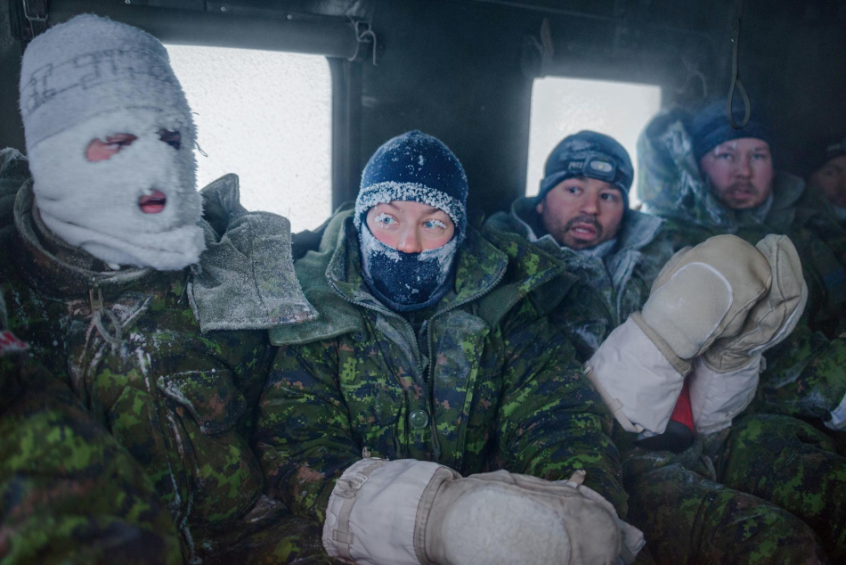 Canadian pilots and aircrew members return to a training facility near Resolute Bay after spending a week living outdoors in makeshift shelters and enduring temperatures as low as minus 58°F. Image by Louie Palu. Canada, 2019.