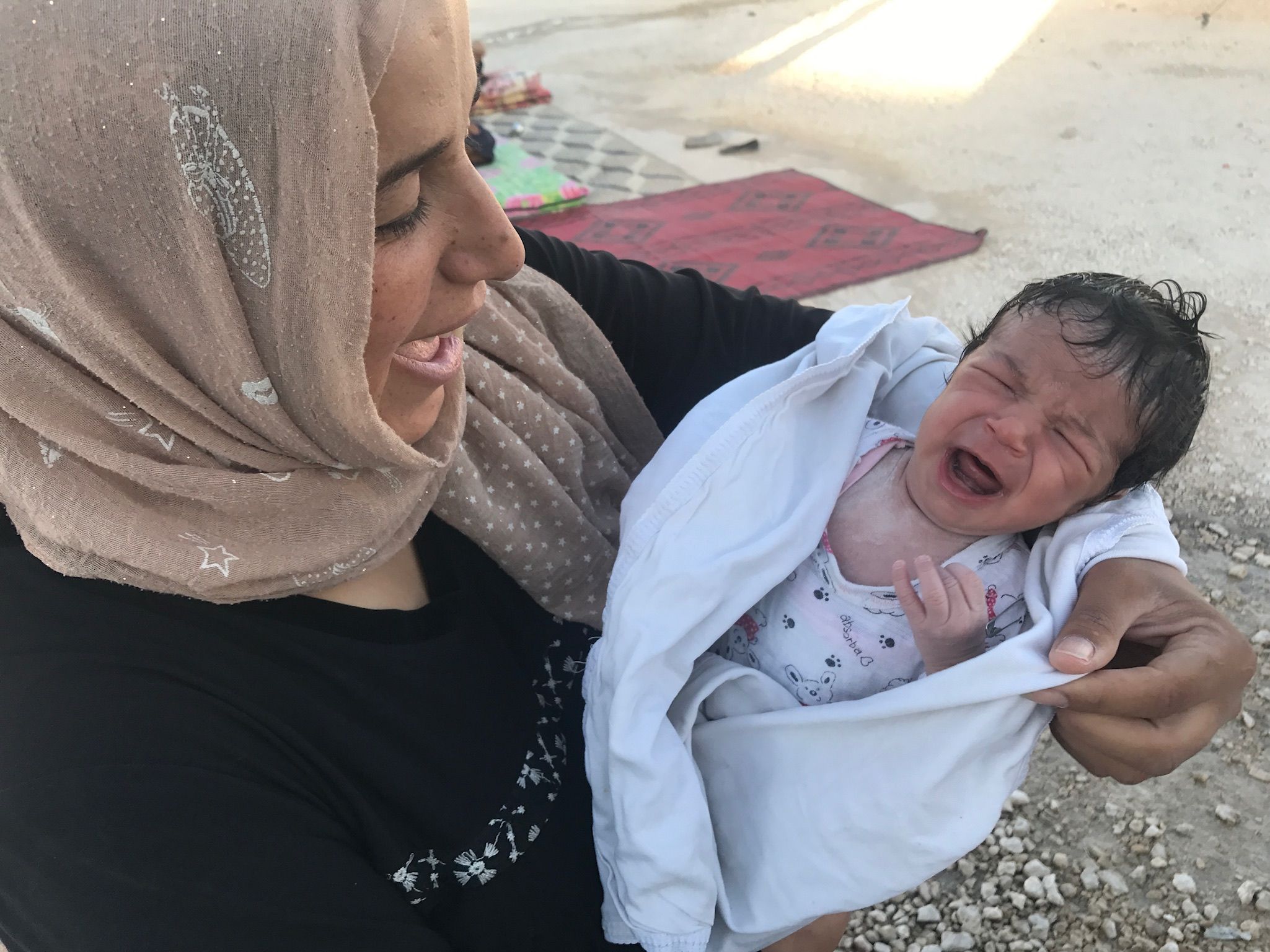 Batoul led her toddler and her husband out of Raqqa while eight-months pregnant. Now, she is focused on her baby’s future while living at Ayn Issa camp for the displaced. Image by Jon Gerberg/PBS NewsHour. Syria, 2017.