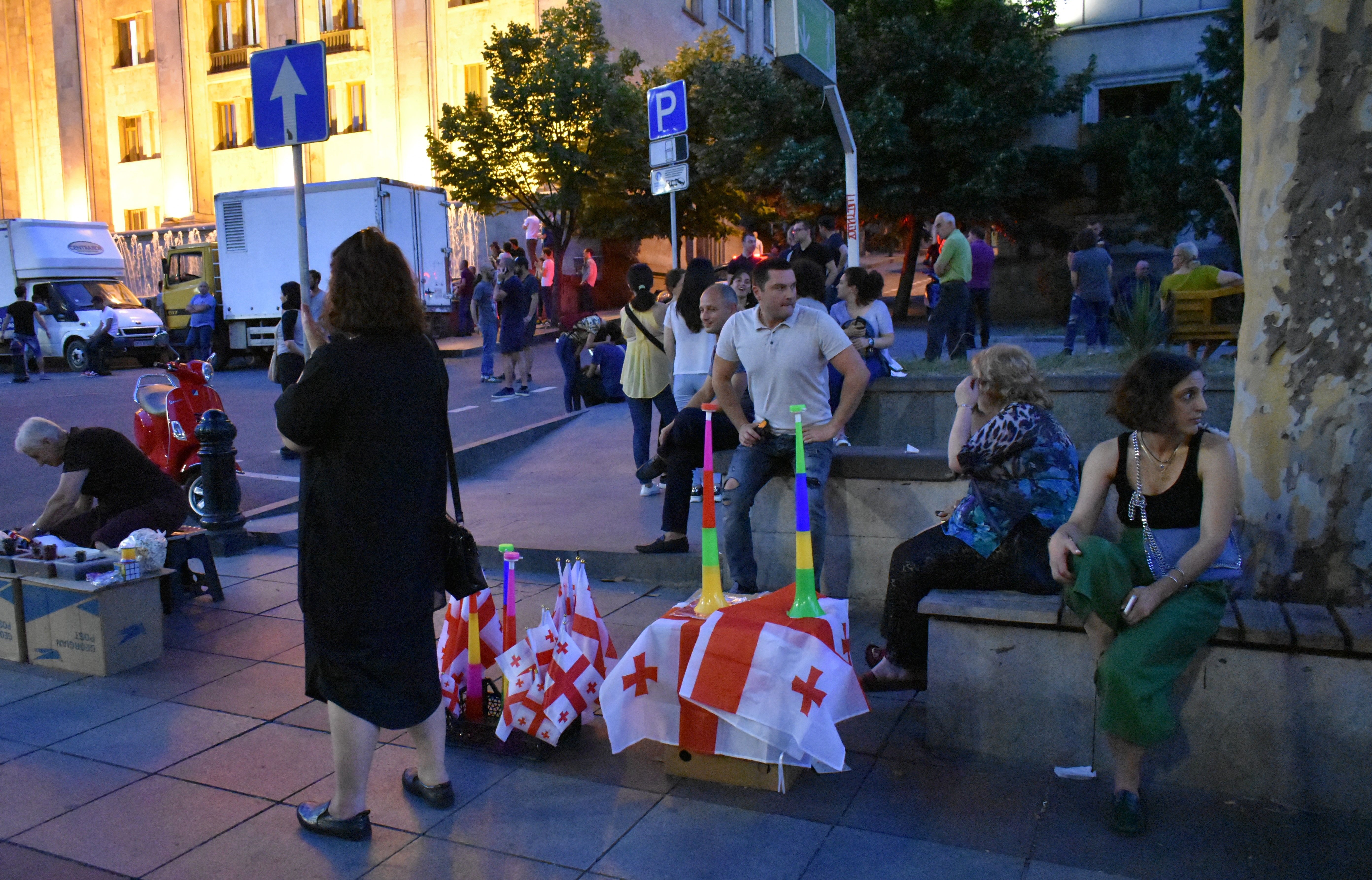 Women sell flags to protesters on Rustaveli Avenue in Tbilisi. Image by Kaitlyn Johnson. Georgia, 2019.