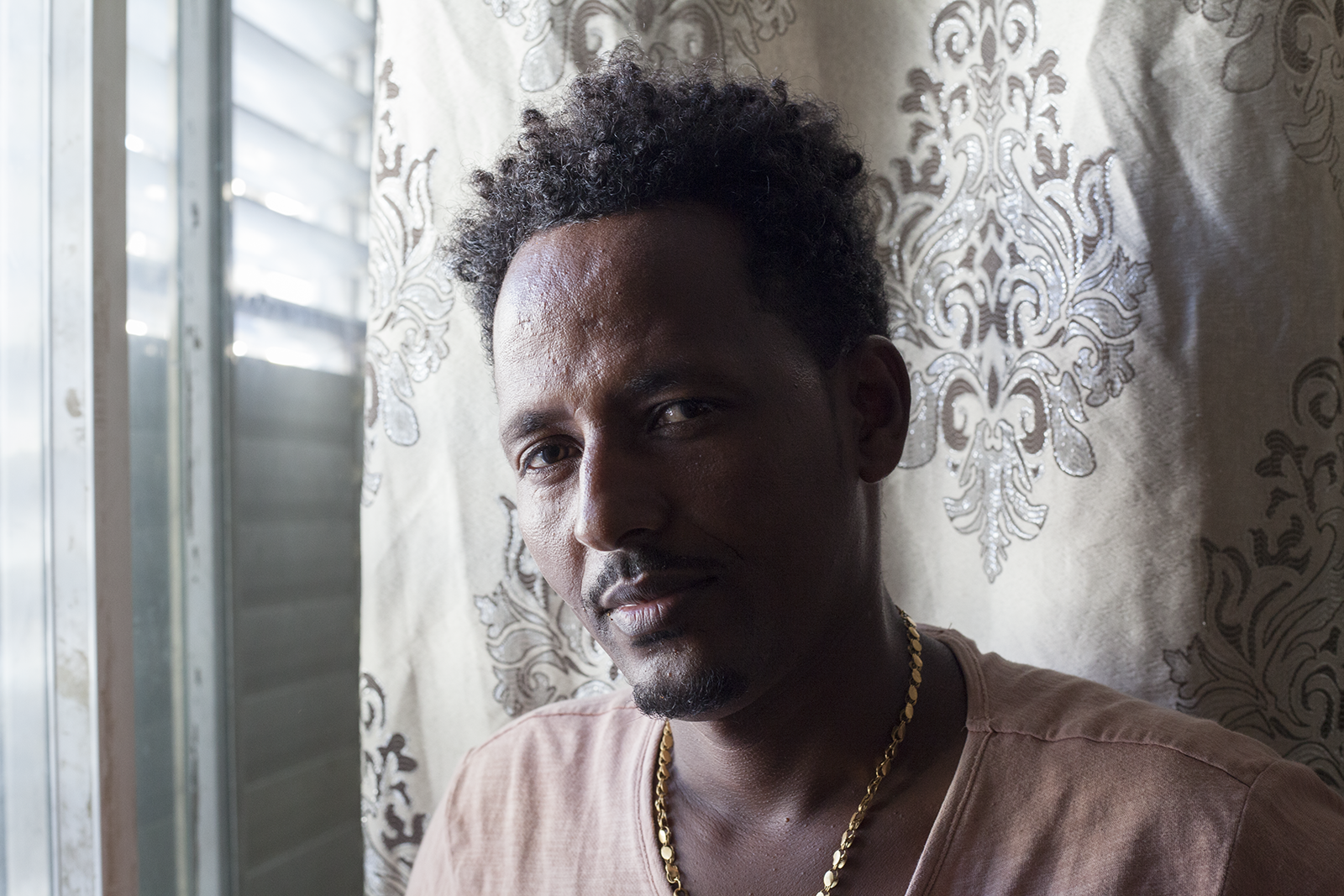 Mesgena (who chose to withhold his last name for privacy reasons), was an asylum seeker from Eritrea living with his wife and four small children in a one bedroom apartment in Tel Aviv. A victim of torture when crossing the Sinai to reach Israel, he was able to receive refugee status in Canada. He and his family were relocated to Toronto in late July. Image by Caron Creighton. Israel, 2018.