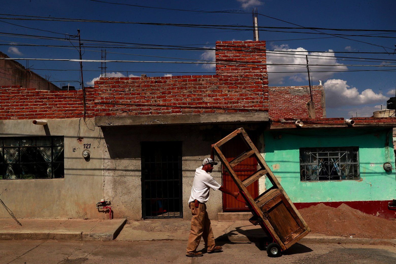 Rafael moves furniture he built in his carpentry shop to his house. Image by Erika Schultz. Mexico, 2019. 