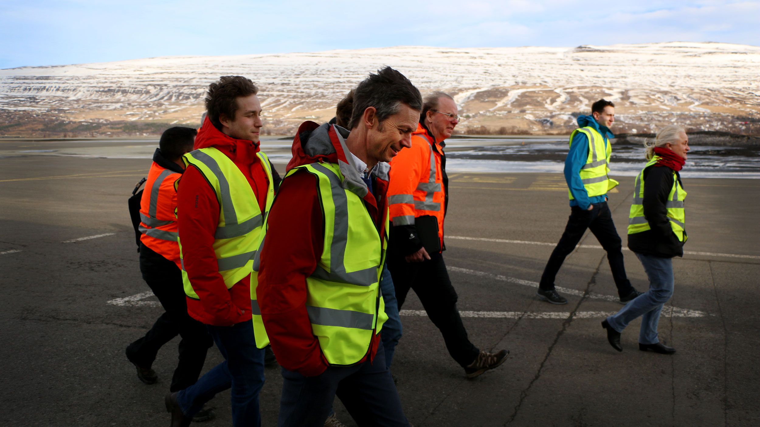 Ian Renfew, front center, and the atmospheric science team walk along the tarmac of the Akureyri airport. Image by Ari Daniel. Iceland, 2018.