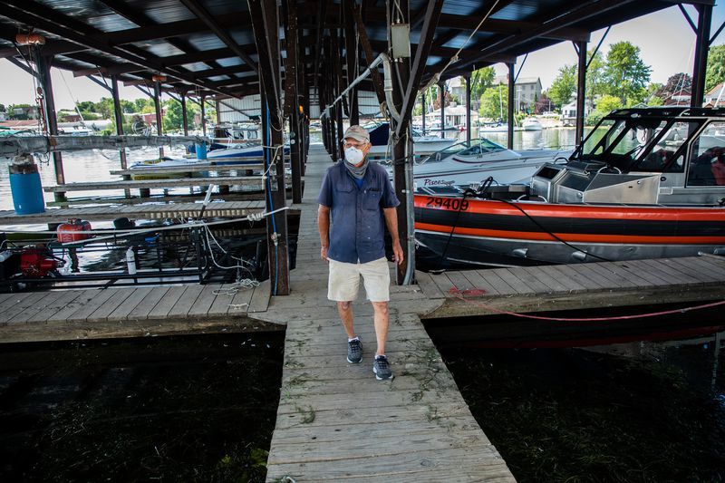 Navy Point Marine co-owner Peter Leubner walks his docks at Sackets Harbor, New York, on July 31, 2020. In 2017, he said, he was forced to shut down the power to the marina as waves crashed in and 35 boat slips were lost. Image by Zbigniew Bzdak/Chicago Tribune. United States, 2020.
